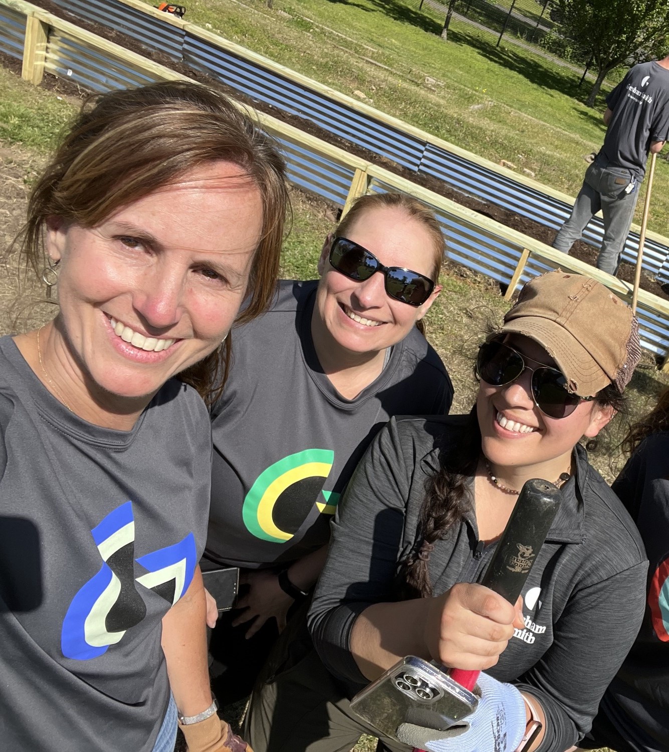 A selfie of three Gresham Smith employees who are participating in an outdoor community service activity