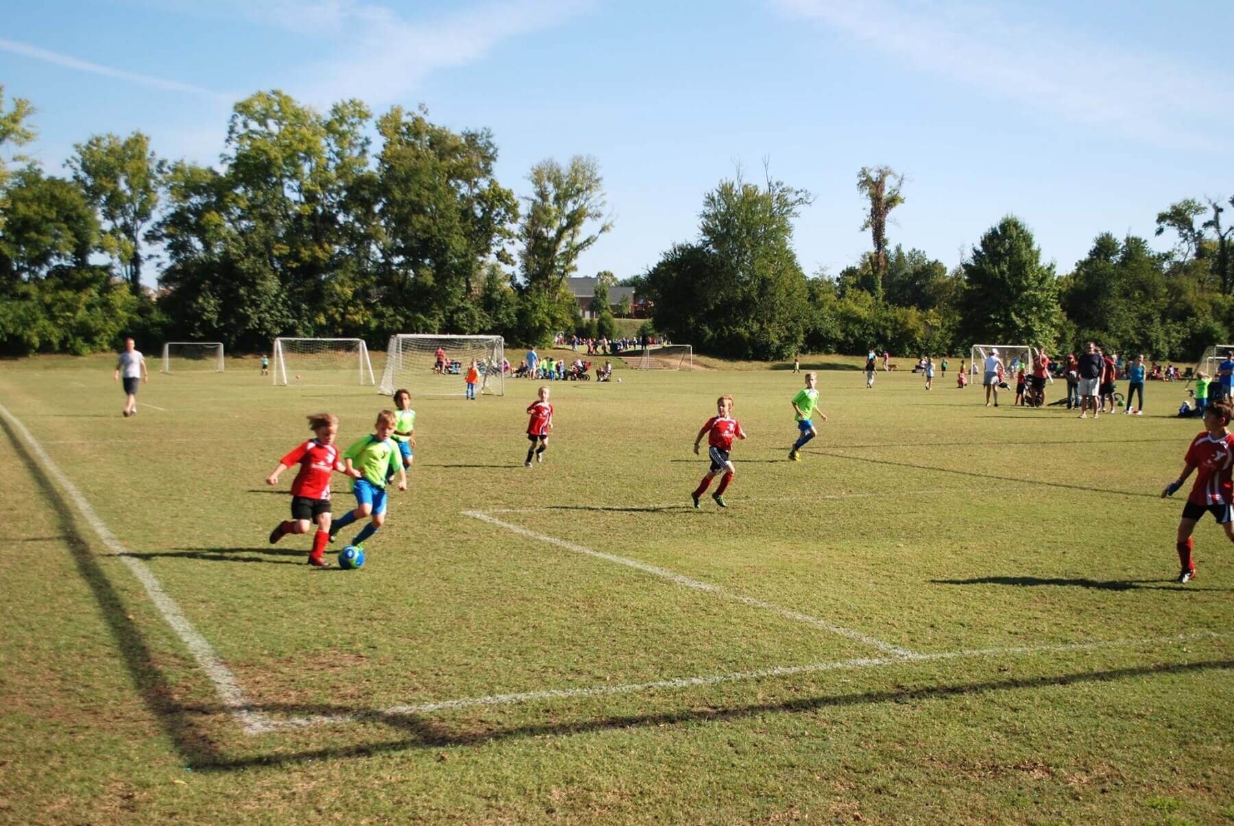 a soccer field with kids playing