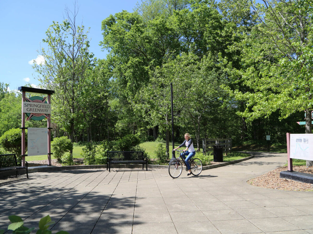 A woman riding a bike at the Springfield Greenway