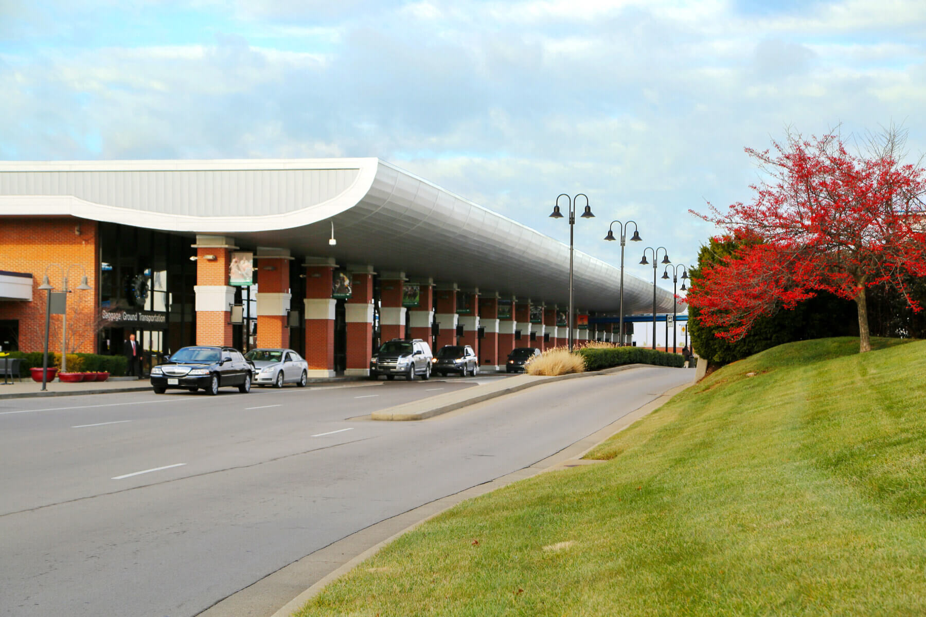 cars parked under the canopy over the curbside outside Lexington, Kentucky’s Blue Grass Airport