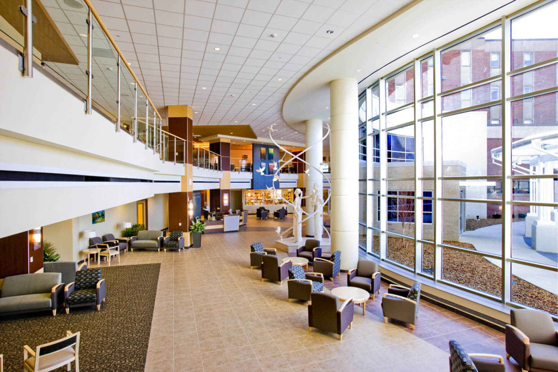two-story lobby with large windows and lots of seating areas