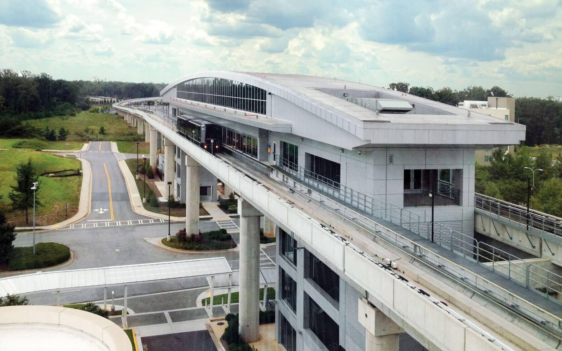 a closer view of an elevated automated people mover station over a roadway at Hartsfield-Jackson Atlanta International Airport