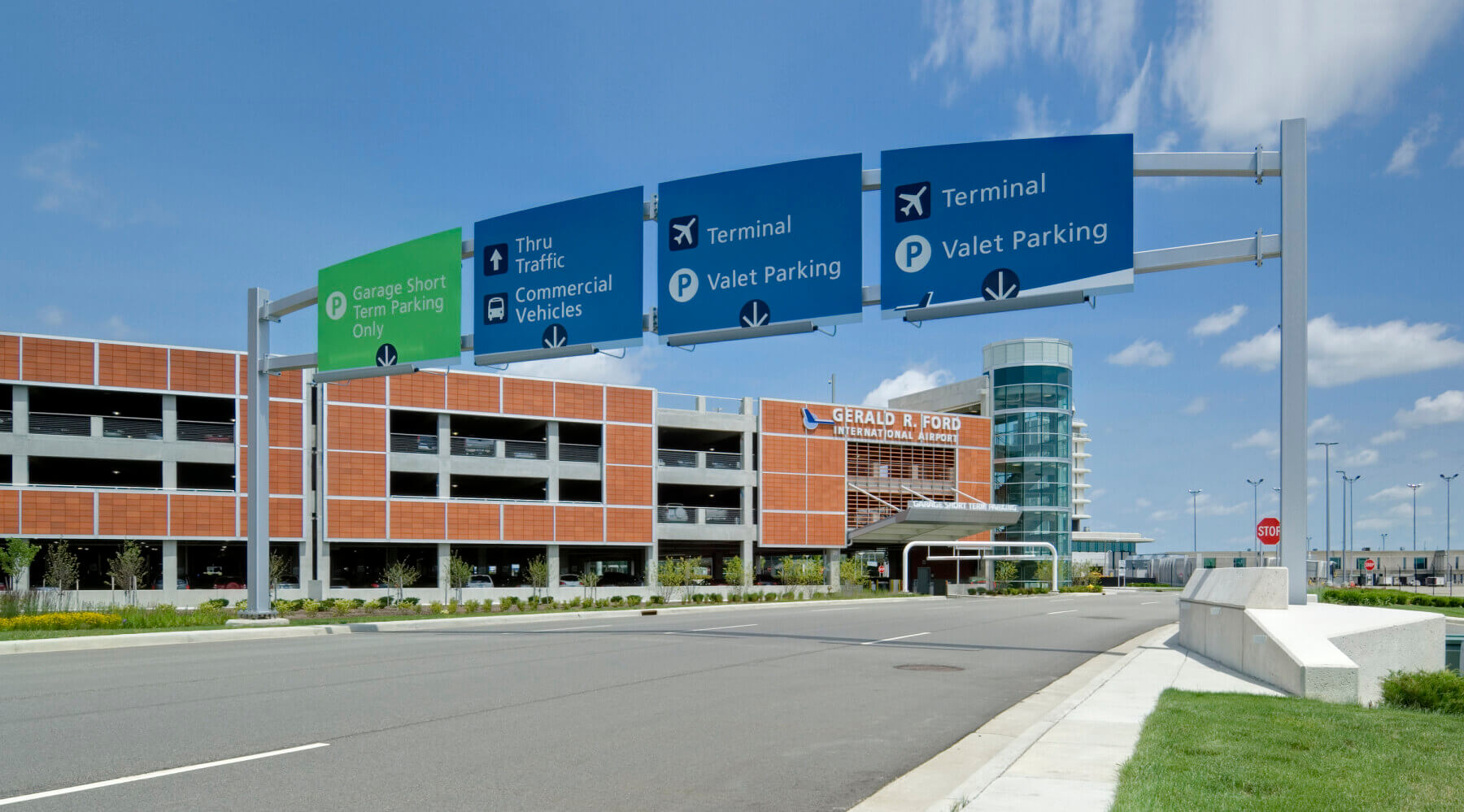 overhead directional signage on the roadway leading to the Gerald R. Ford International Airport parking garage