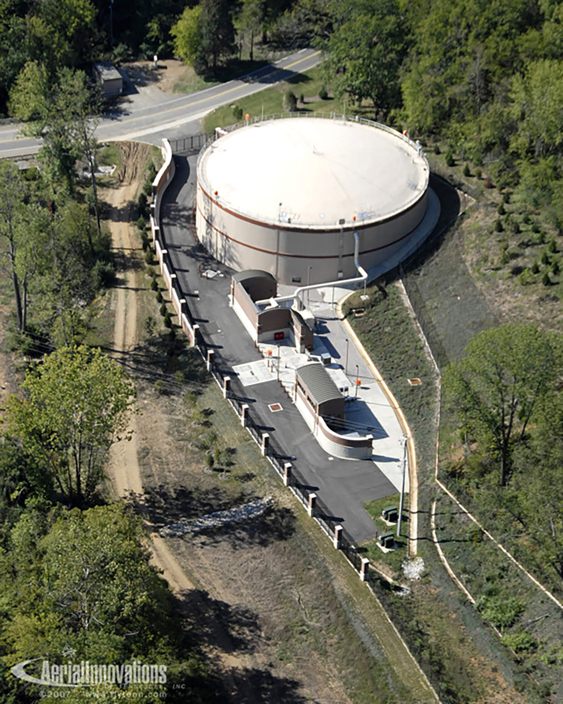Aerial view of circular, pre-stressed concrete equalization basin at Fourth Creek/Walker Springs Pump Station.