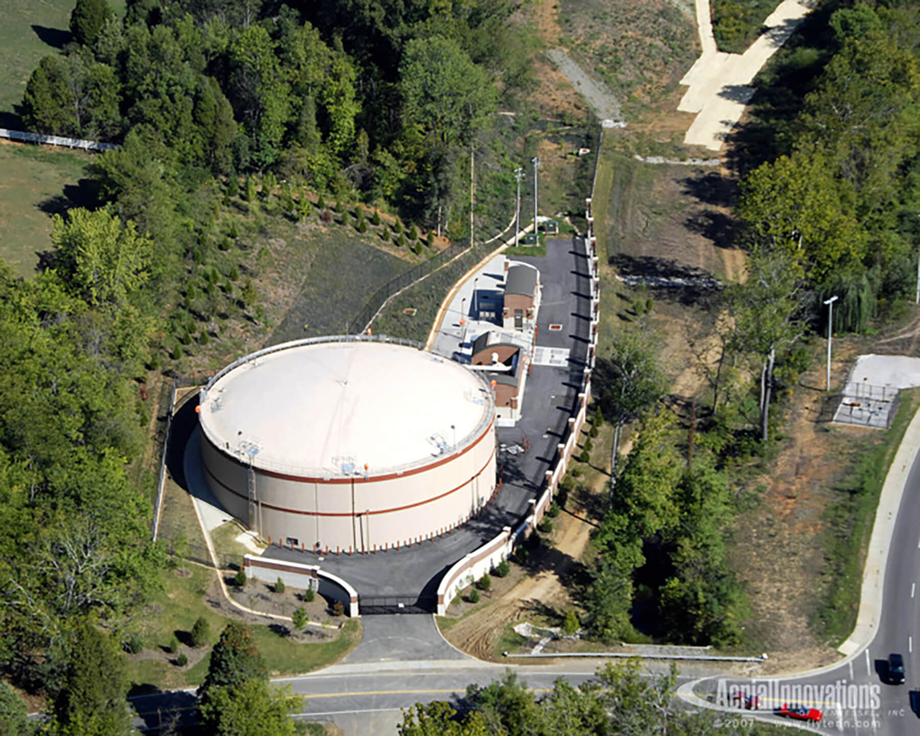 Aerial view of circular, pre-stressed concrete equalization basin at Fourth Creek/Walker Springs Pump Station.