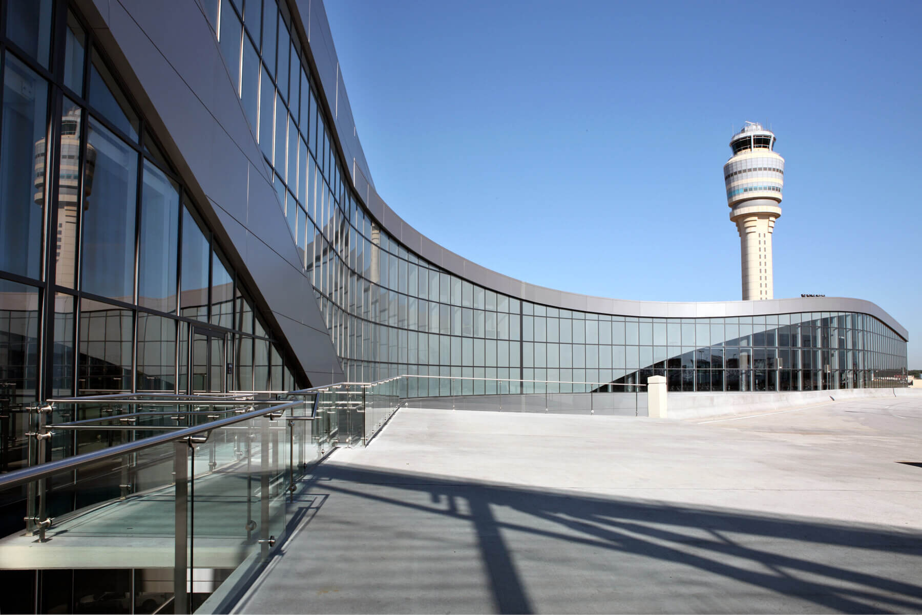the façade of the international terminal at Hartsfield-Jackson Atlanta International Airport with the air traffic control tower in the distance