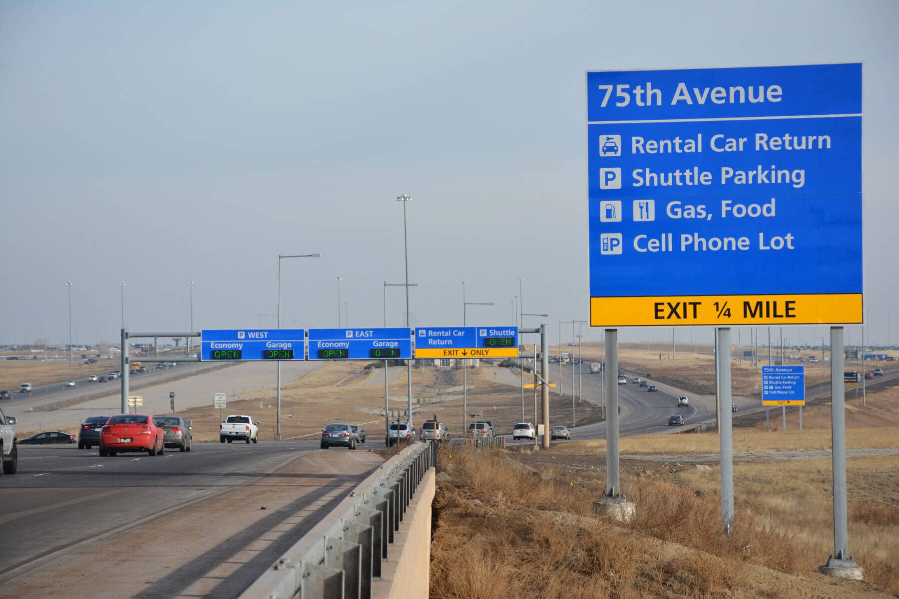 overhead directional signage on the roadway leading to Denver International Airport