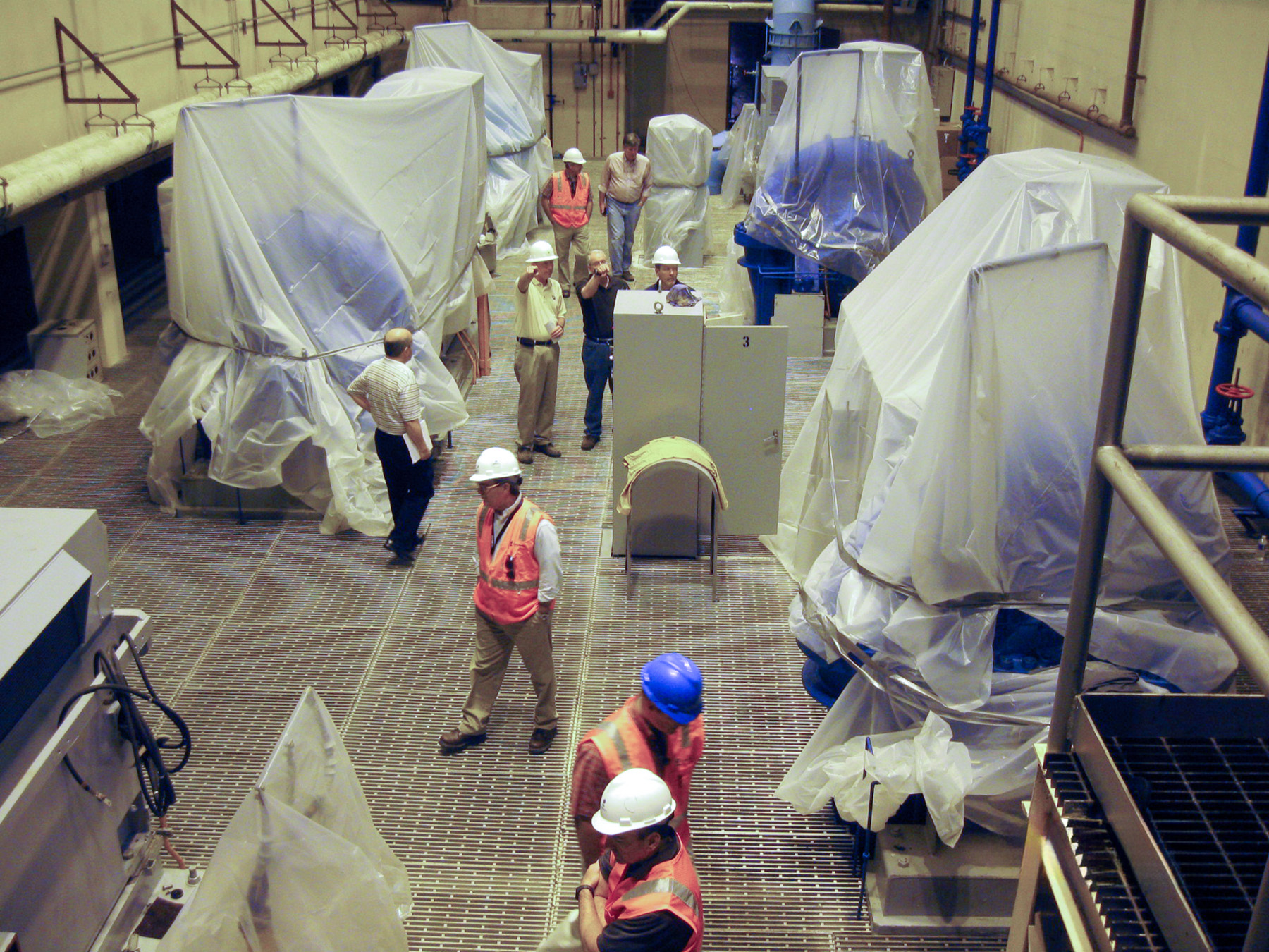 Workers with hard hats prepare to test equipment at K.R. Harrington Water Treatment Plant.
