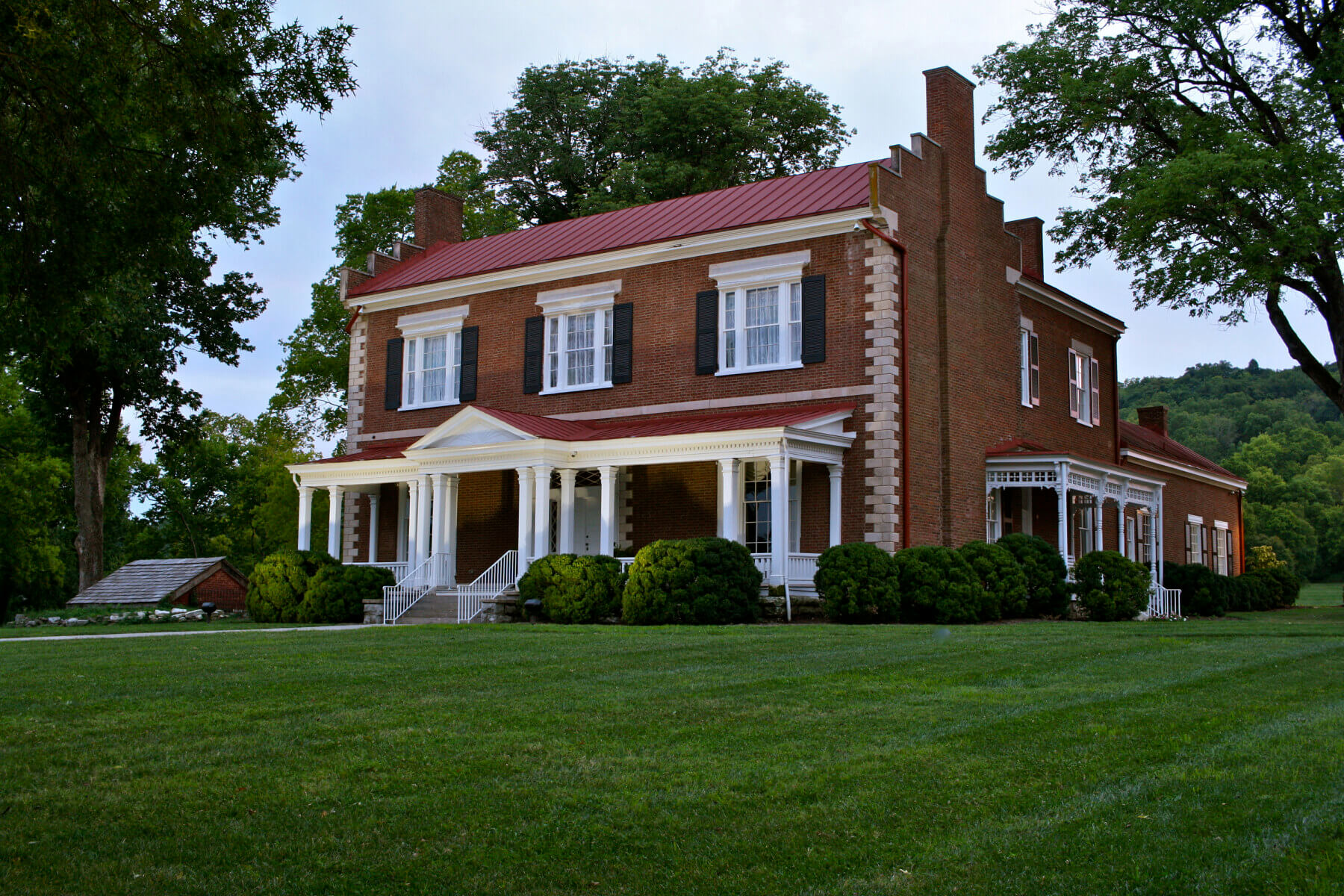 A historic home with grass and trees in the background at Marcella Vivrette Smith Park