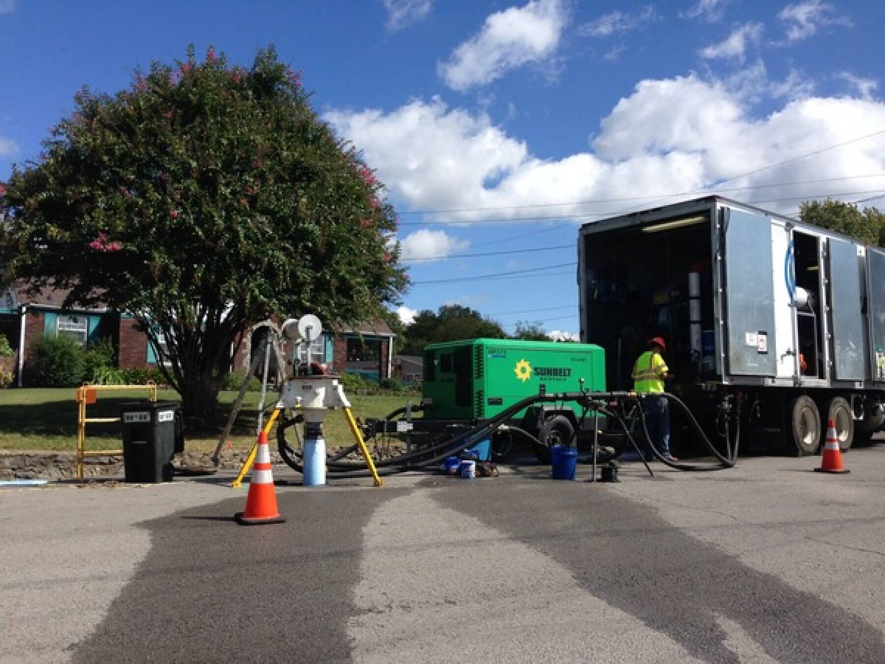A green diesel generator and truck seen carrying out sewer rehab.