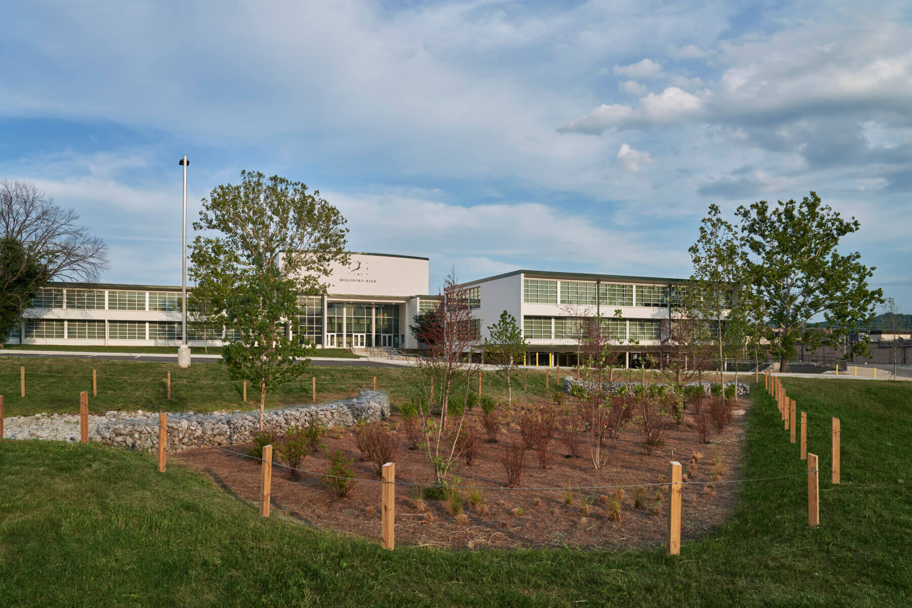 The front of the Hillsboro High School building and surrounding grass and trees