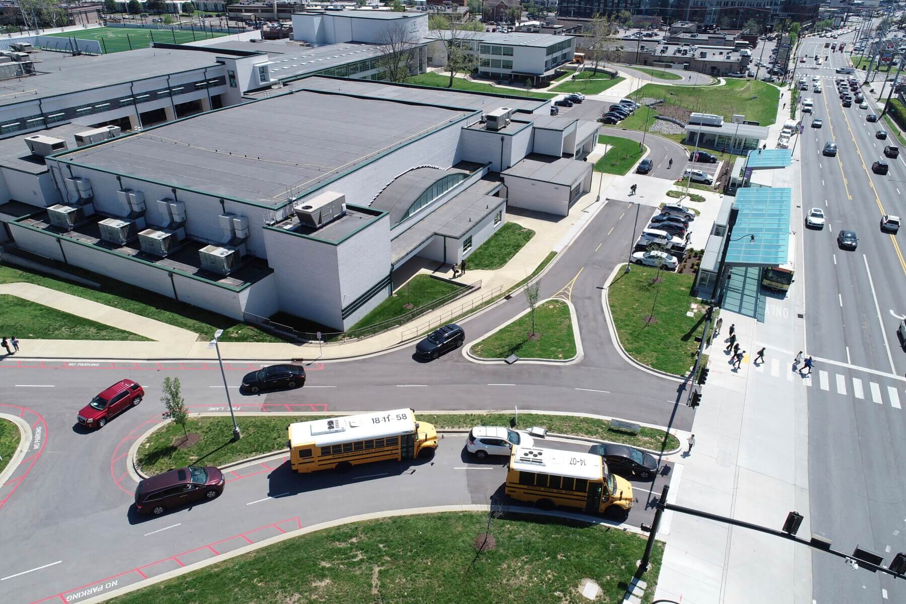 An aerial shot of cars and busses outside of Hillsboro High School