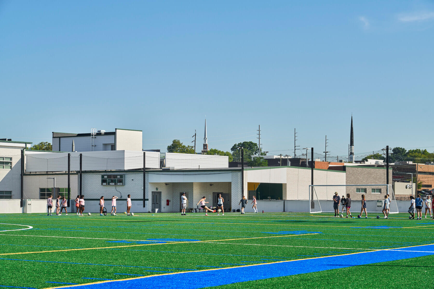 A group of people playing at a soccer field at Hillsboro High School