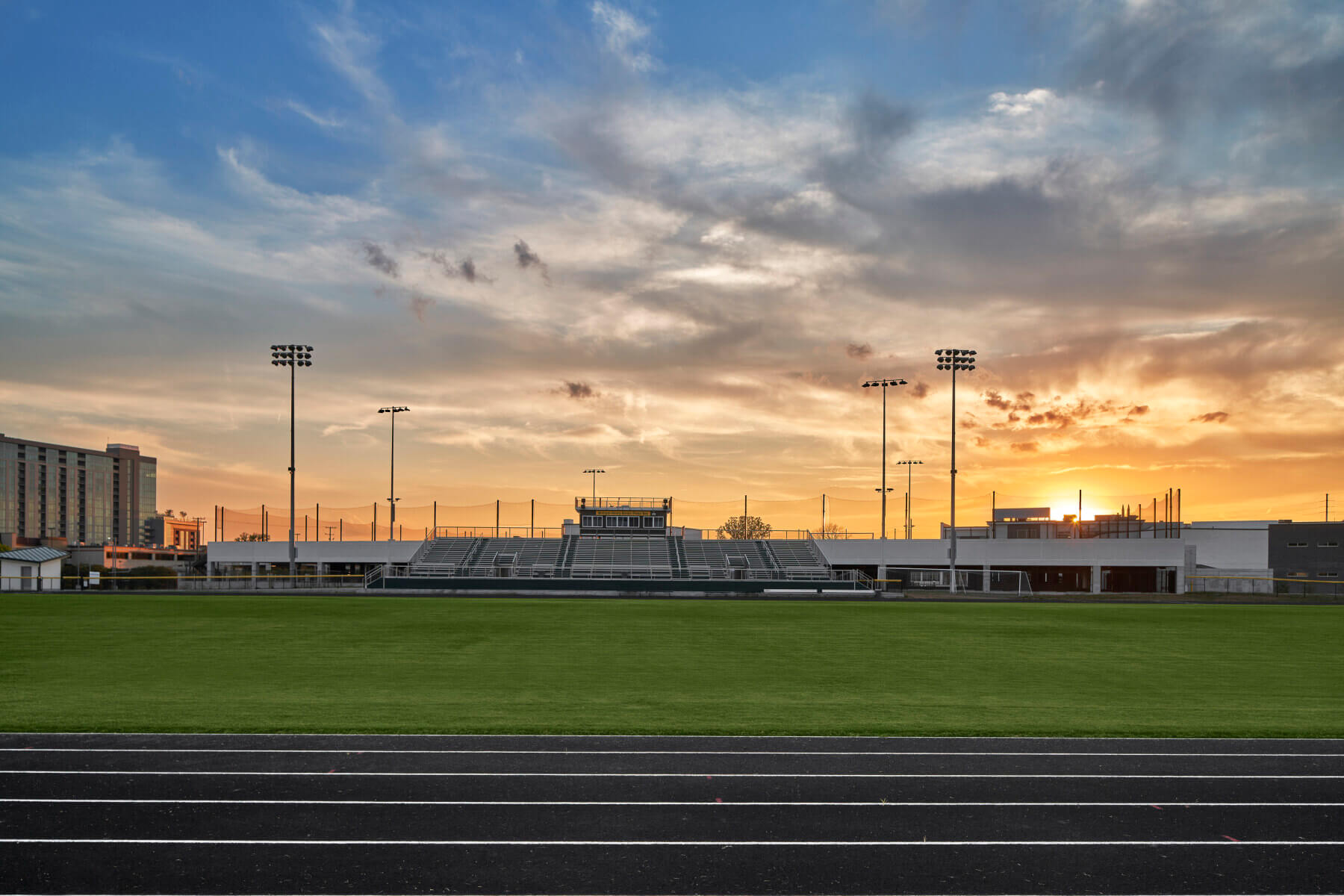 A field and a sunset behind at Hillsboro High School