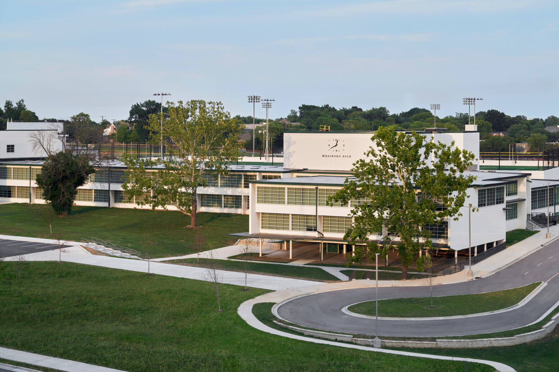 The outside of Hillsboro High School with trees and grass surrounding
