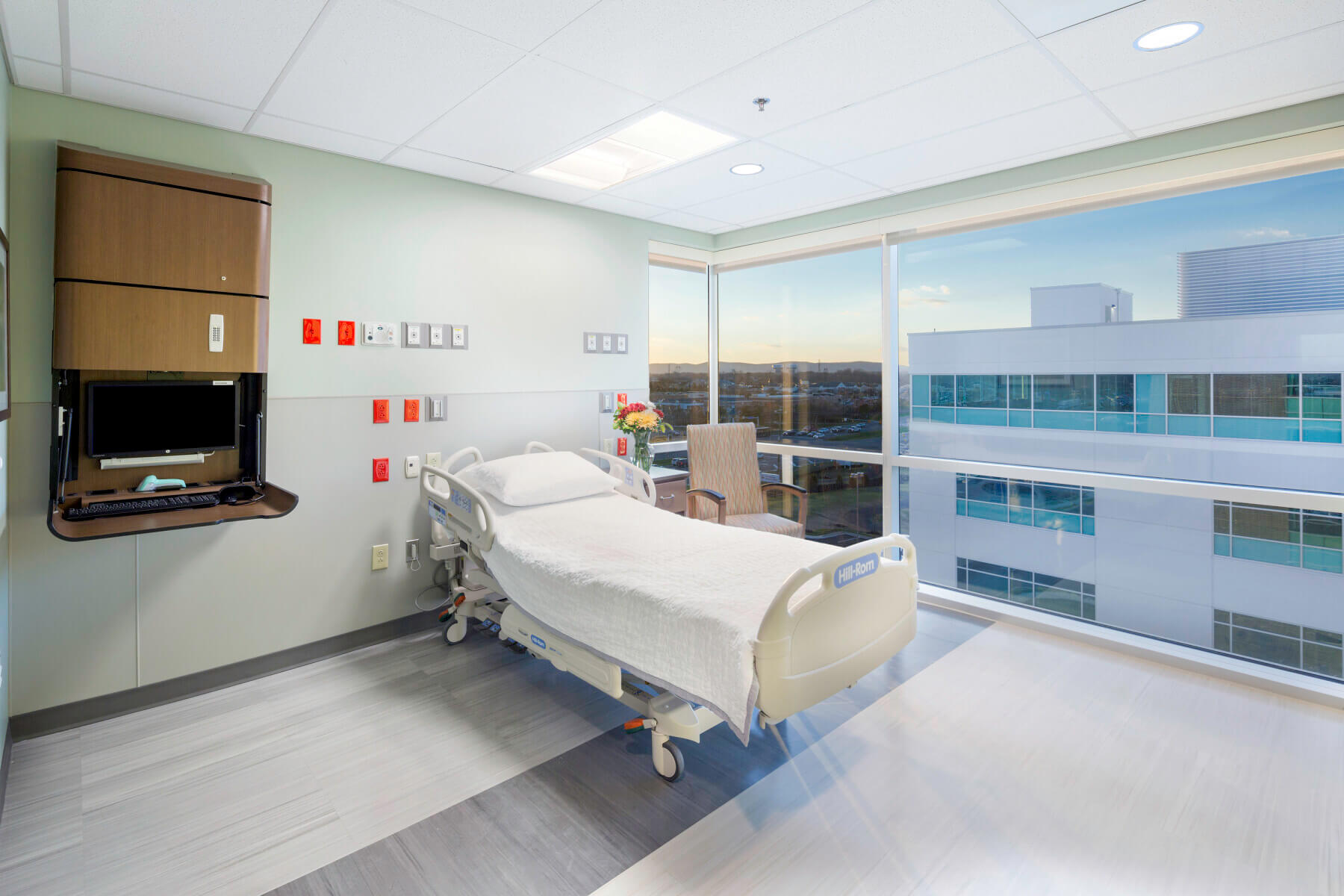 patient room with unoccupied bed and skyline view