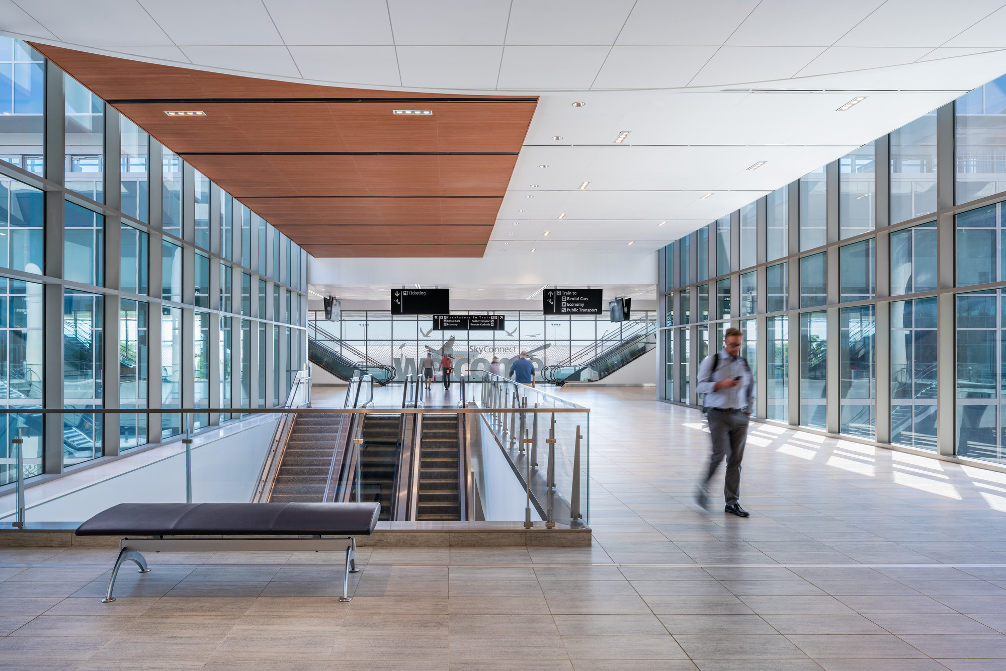 travelers walking through a skyconnect corridor at tampa international airport