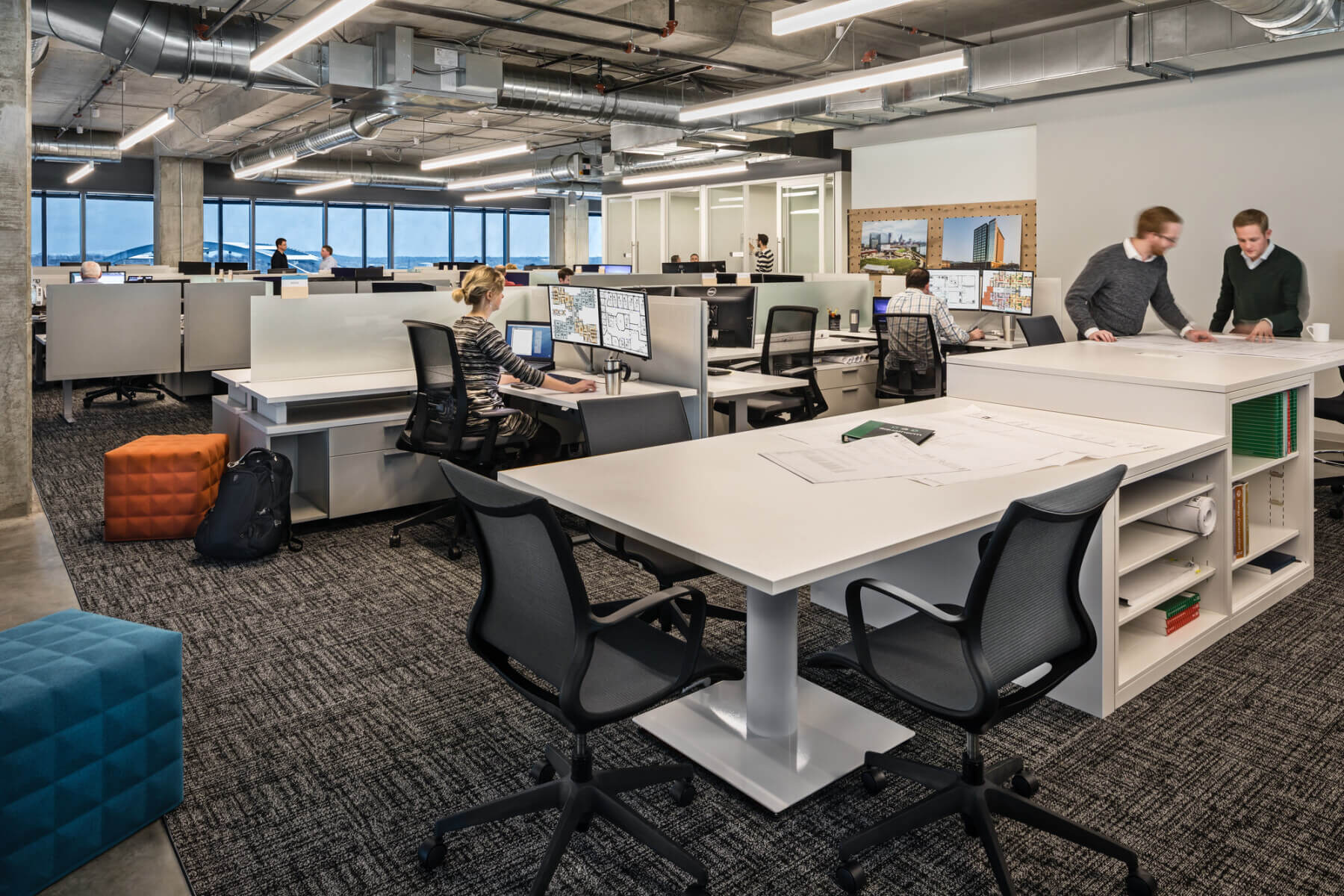 employees work individually and together within office workspace