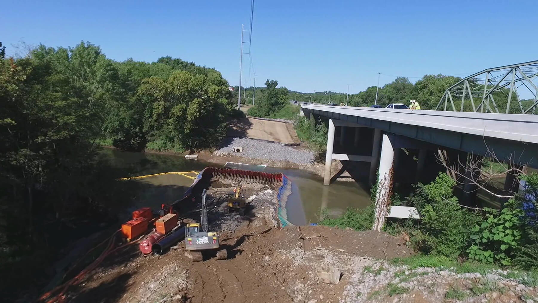 Pipe installation under river besides bridge