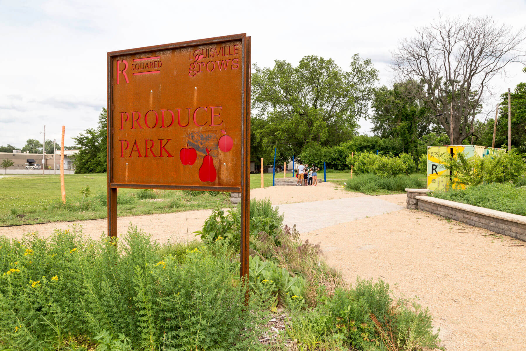 a metal sign that says Rsquared Produce Park