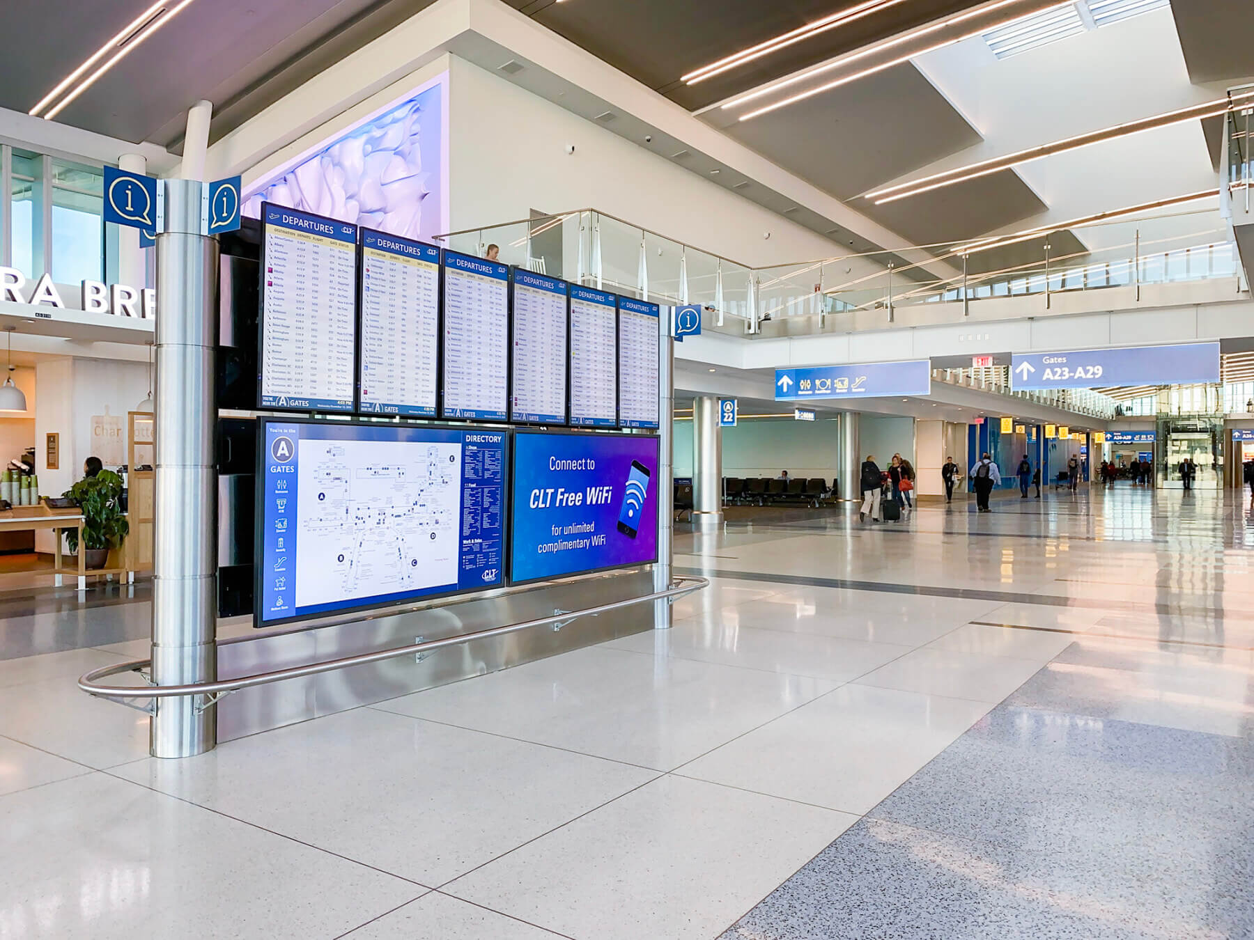 a large, freestanding digital sign in the concourse at Charlotte Douglas International Airport