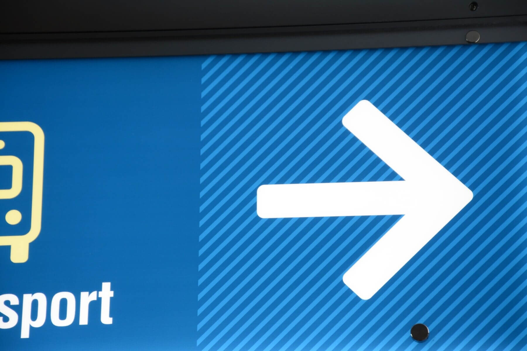 a close up view of the blue stripe pattern on wayfinding signage at Charlotte Douglas International Airport