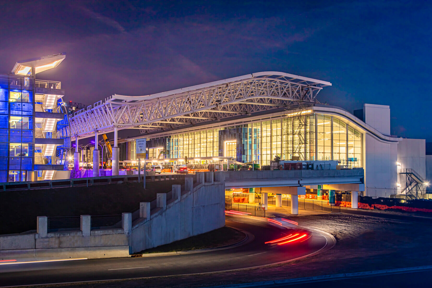 the steel canopy over the curbside outside the Charlotte Douglas International Airport terminal at dusk