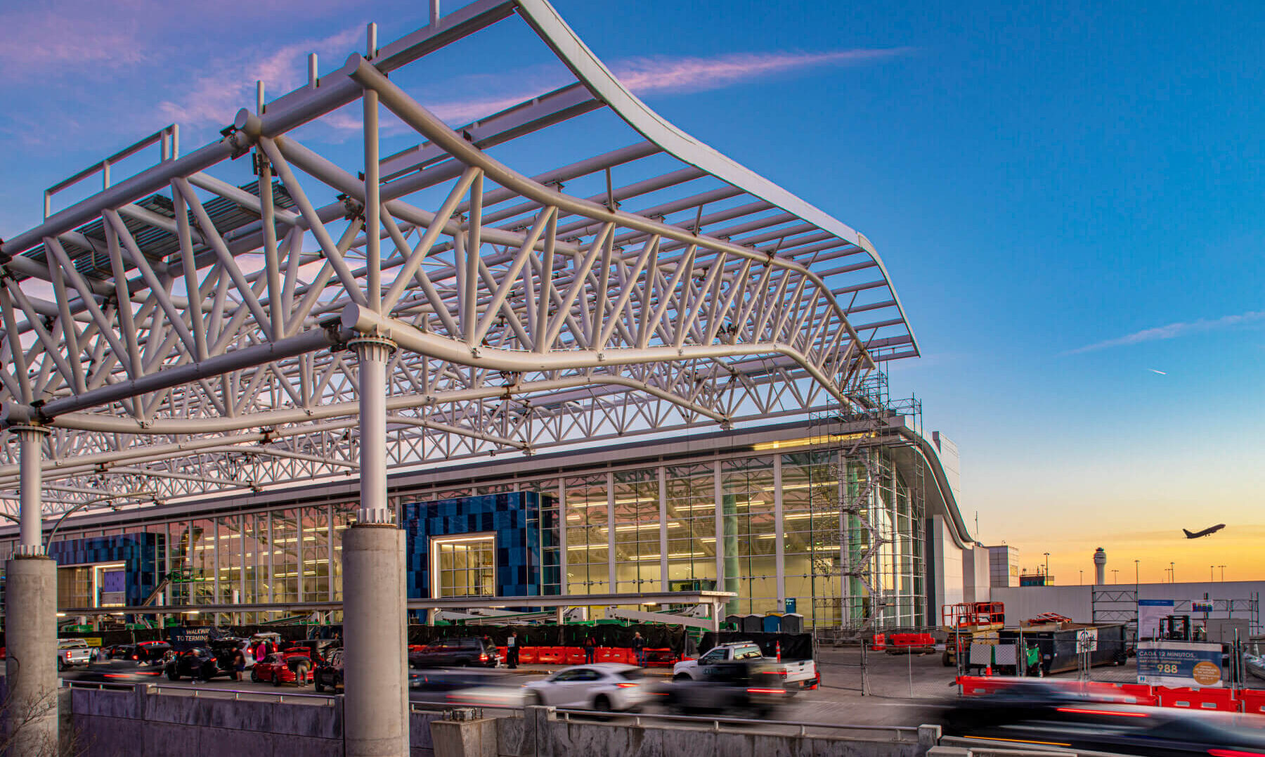 the steel canopy over the curbside outside the Charlotte Douglas International Airport terminal during the daytime
