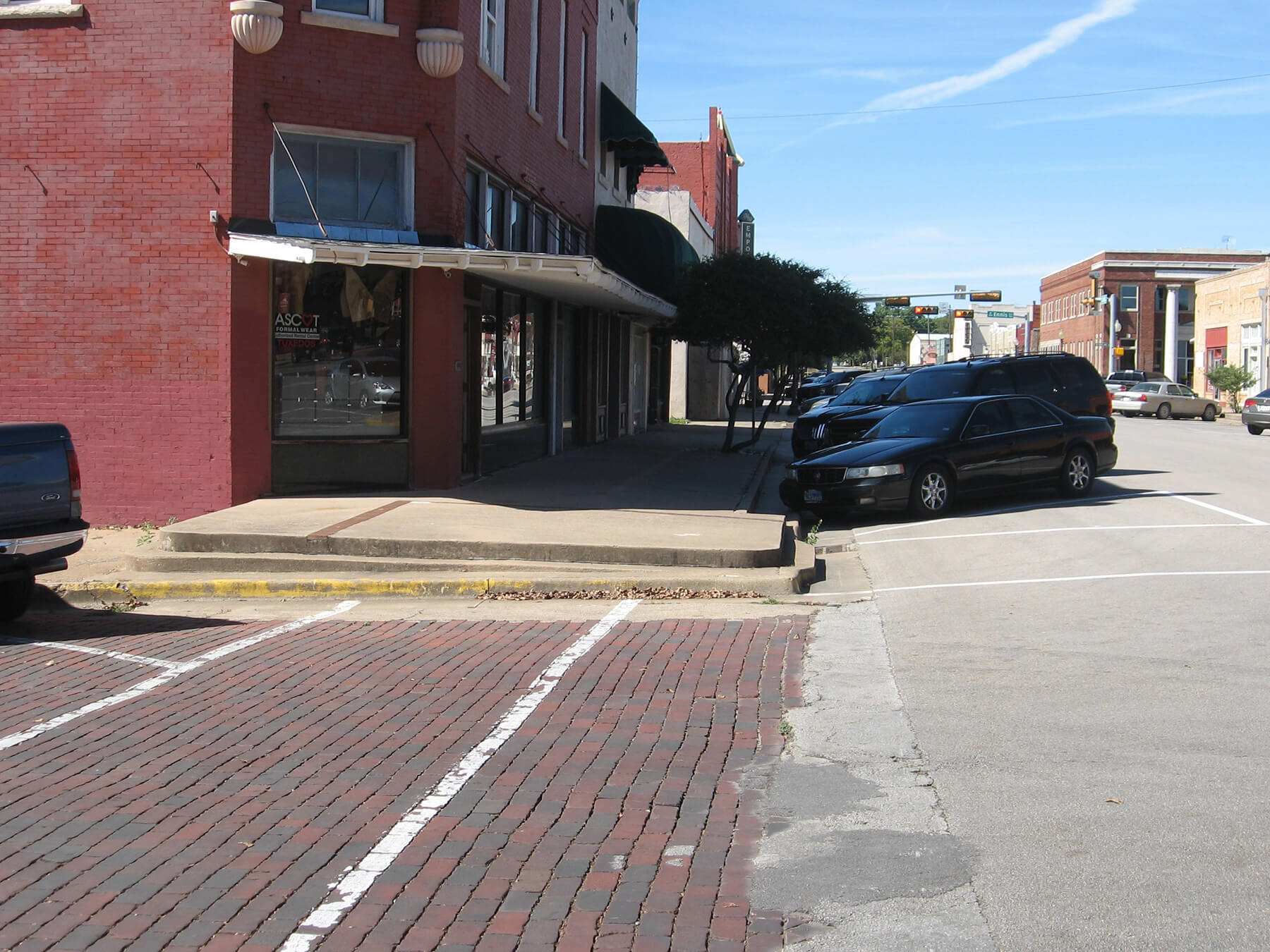 Cars parked on street in downtown Ennis prior to construction