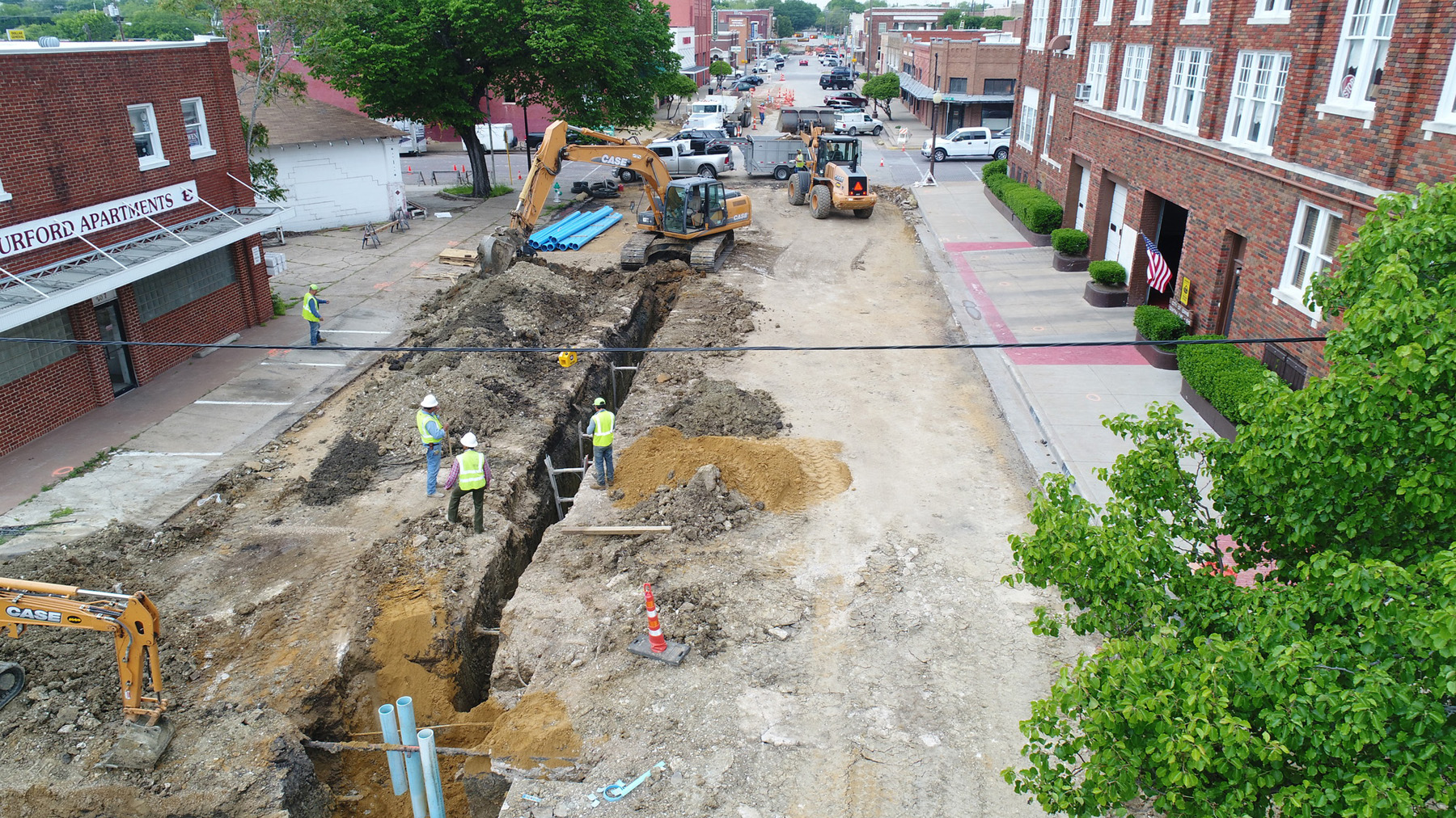 Construction workers lay new underground utilities in downtown Ennis
