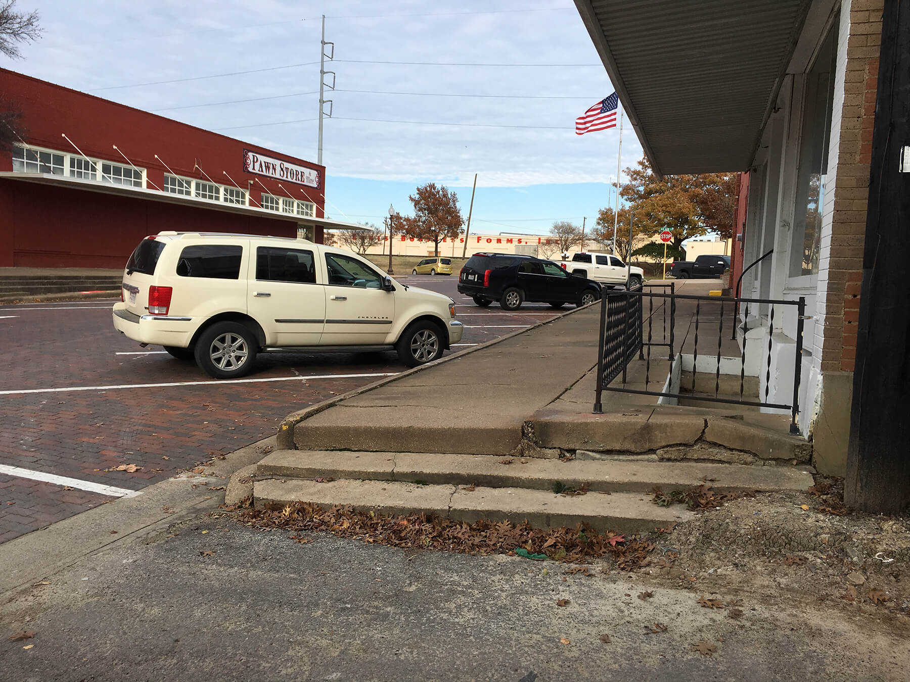 White SUV parked in downtown Ennis prior to construction