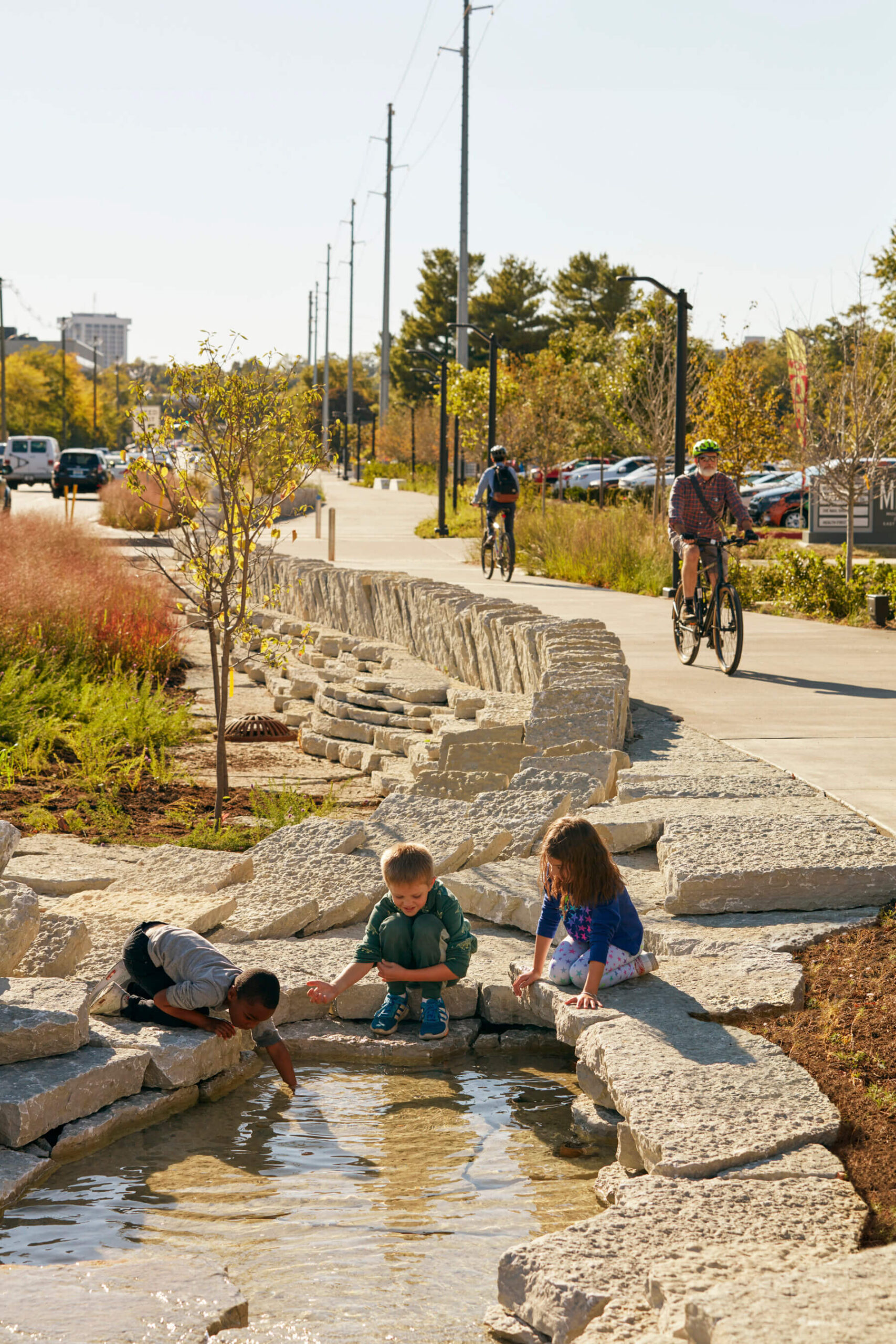 children playing in a flowing stream in Town Branch Commons