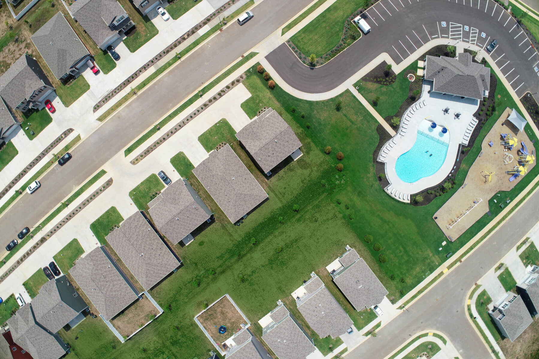 a drone shot of Heritage Landing showing a pool and houses