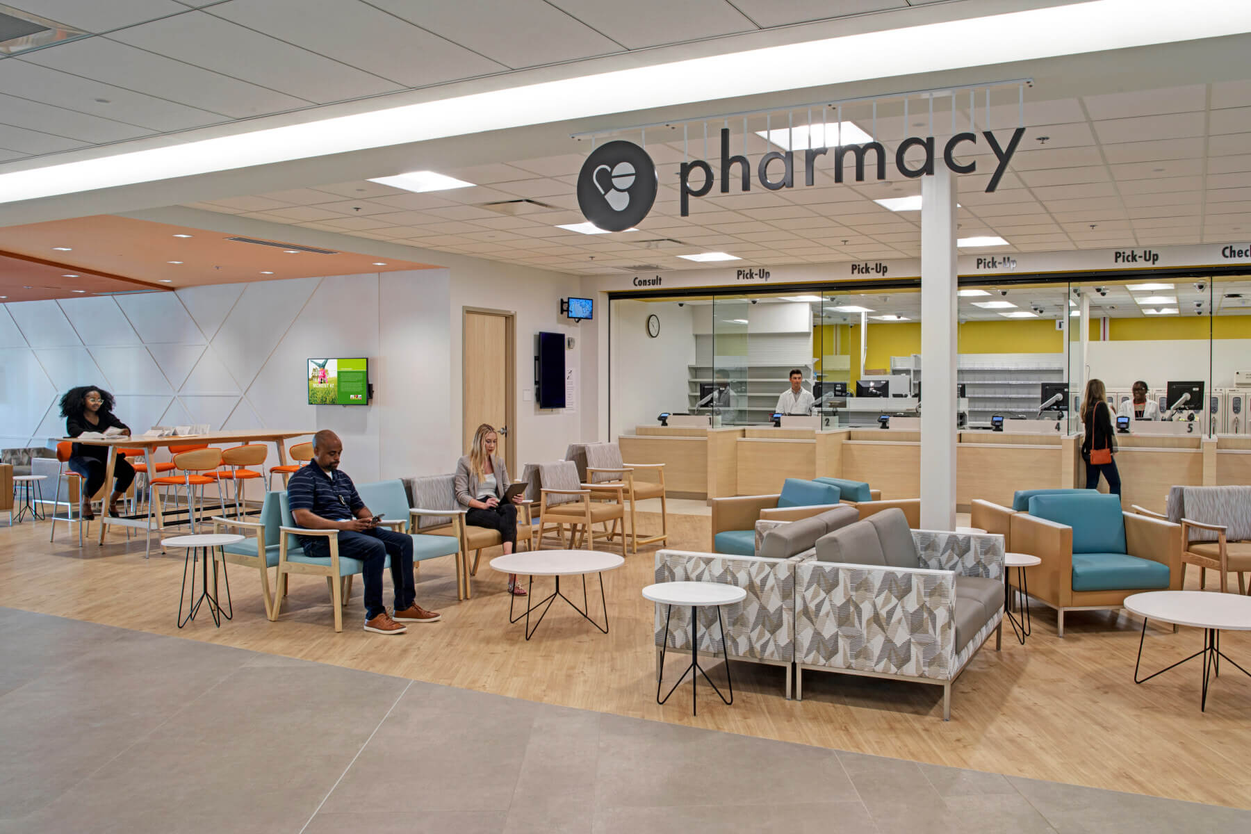 several people sit in the waiting are of the on-campus pharmacy