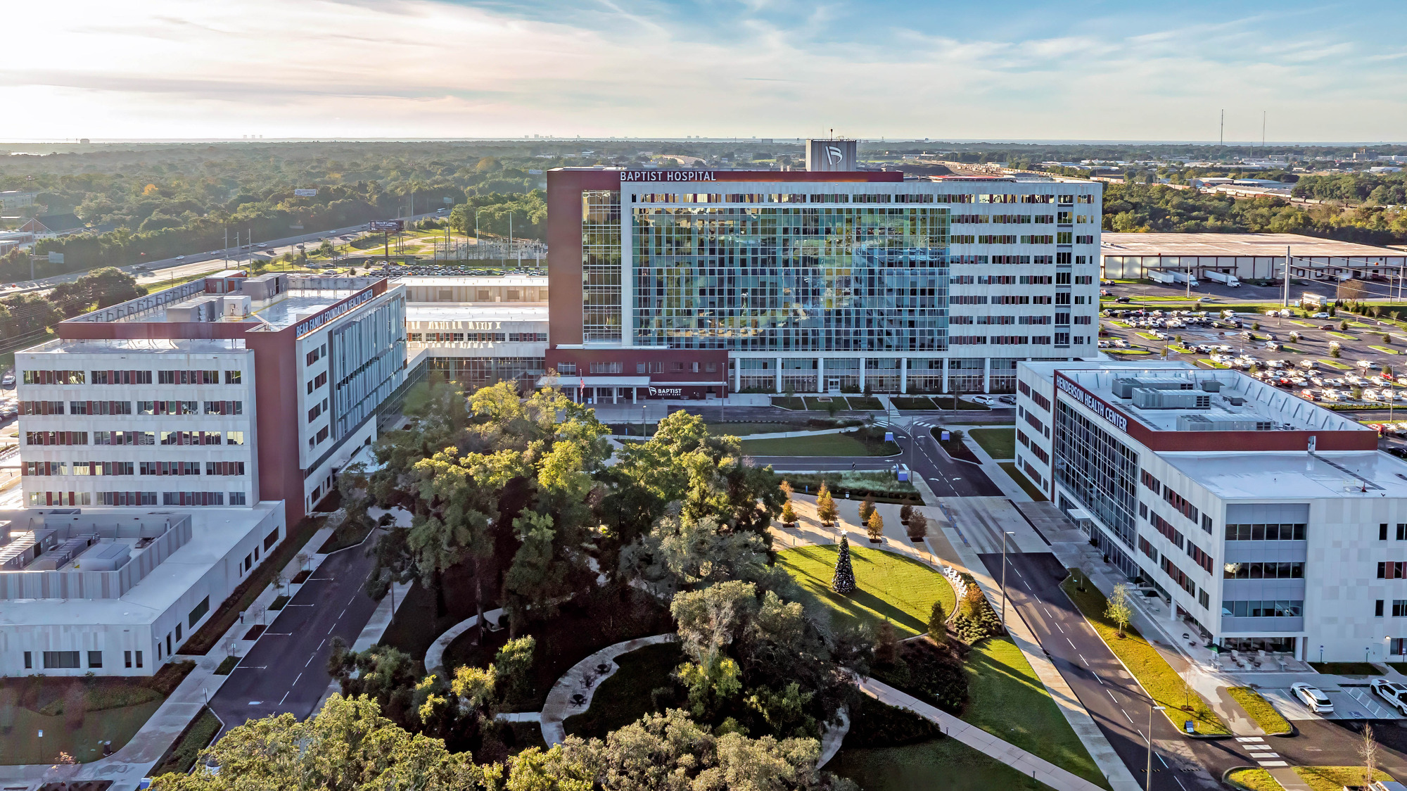 aerial view of hospital campus with three buildings around a park