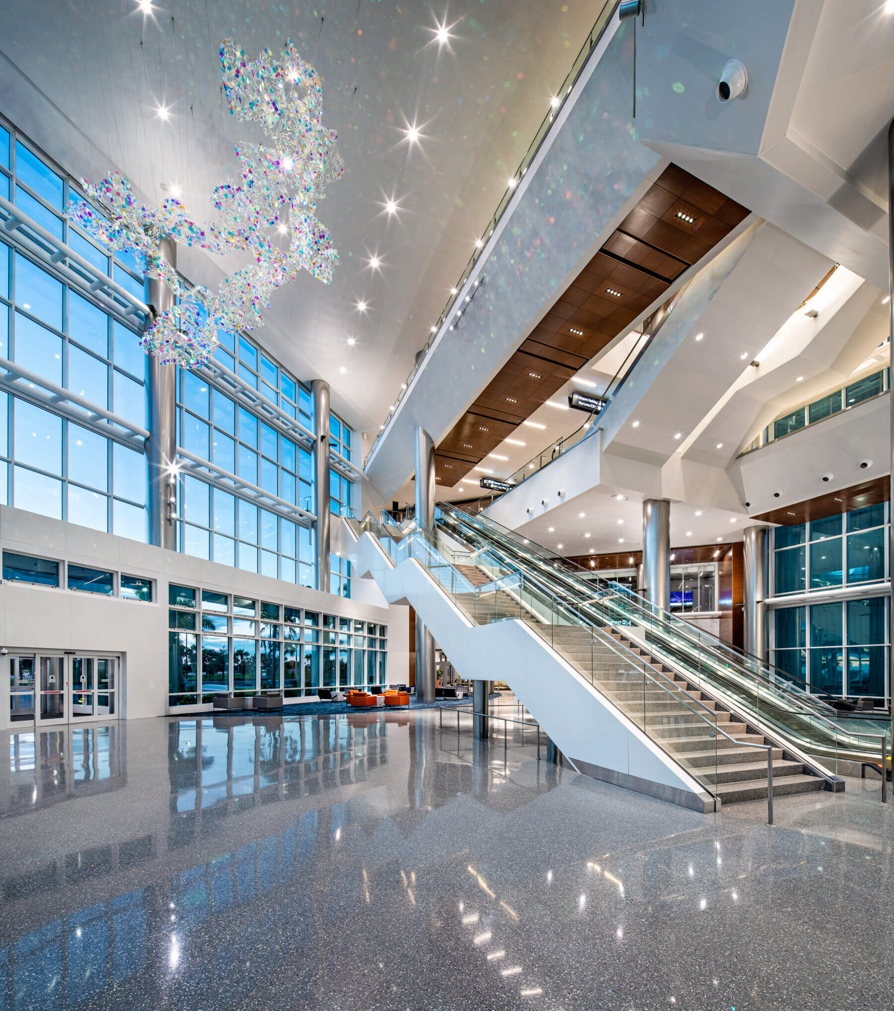 monumental staircase and art sculpture hanging from the ceiling in the artrium at the SkyCenter development at Tampa International Airport