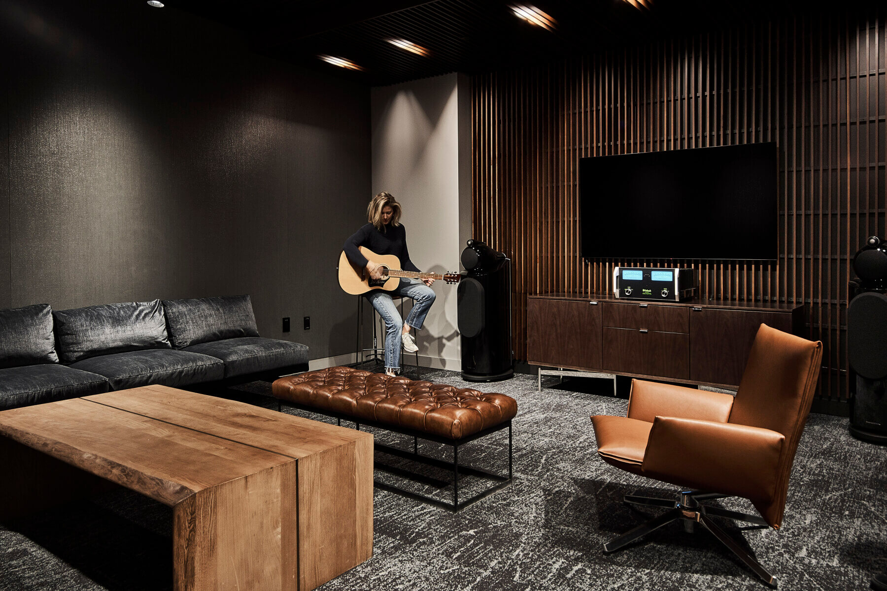 The listening room with a person playing a guitar in the Universal Music Group Nashville offices
