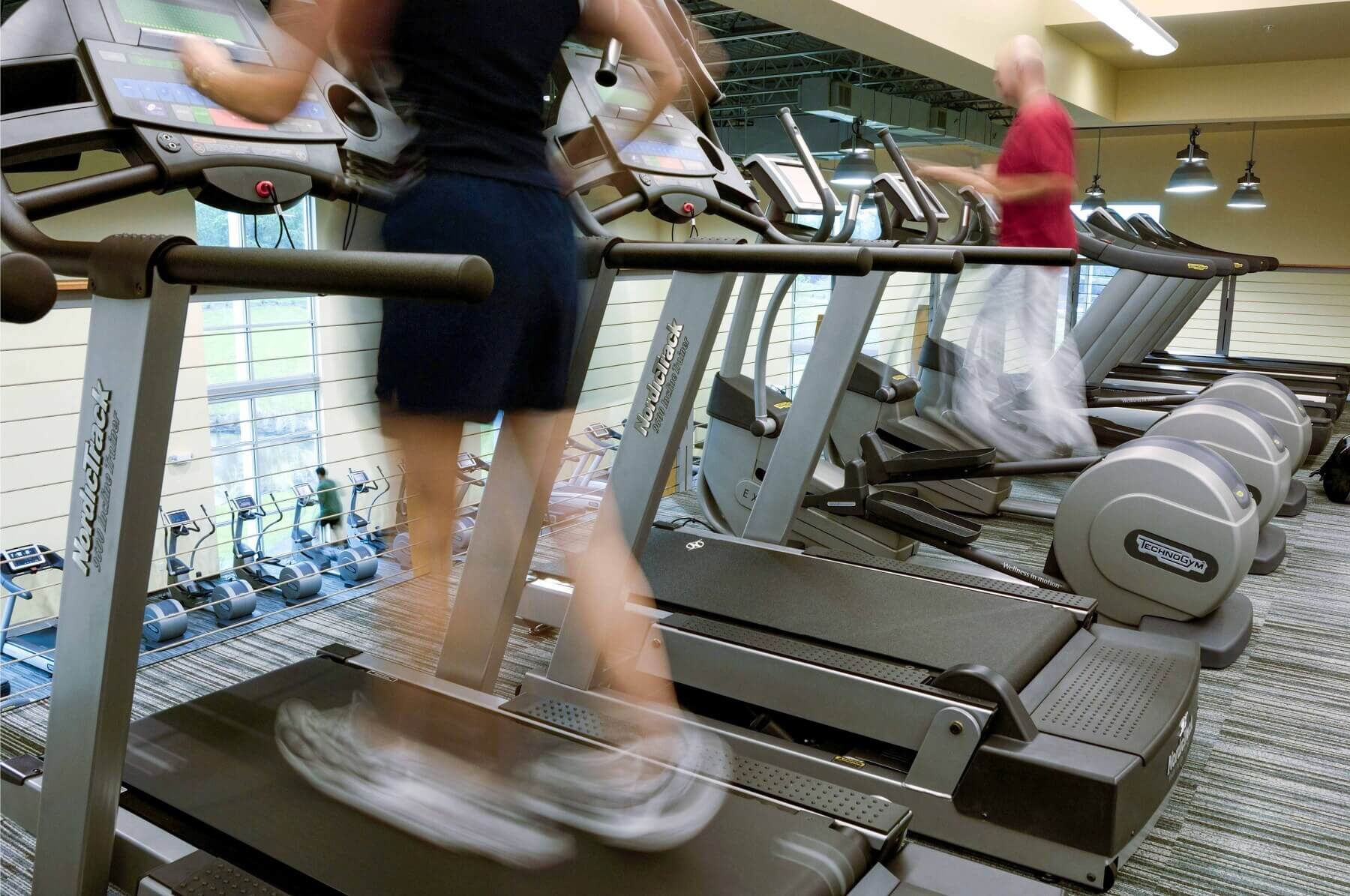 patients running on treadmills at the Brooks Rehabilitation Center