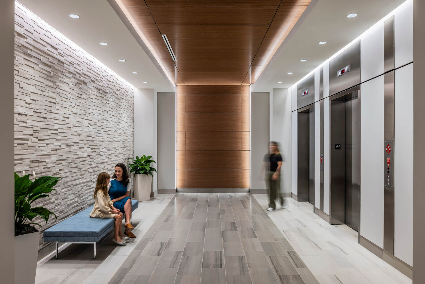 lobby with seating outside of building elevators