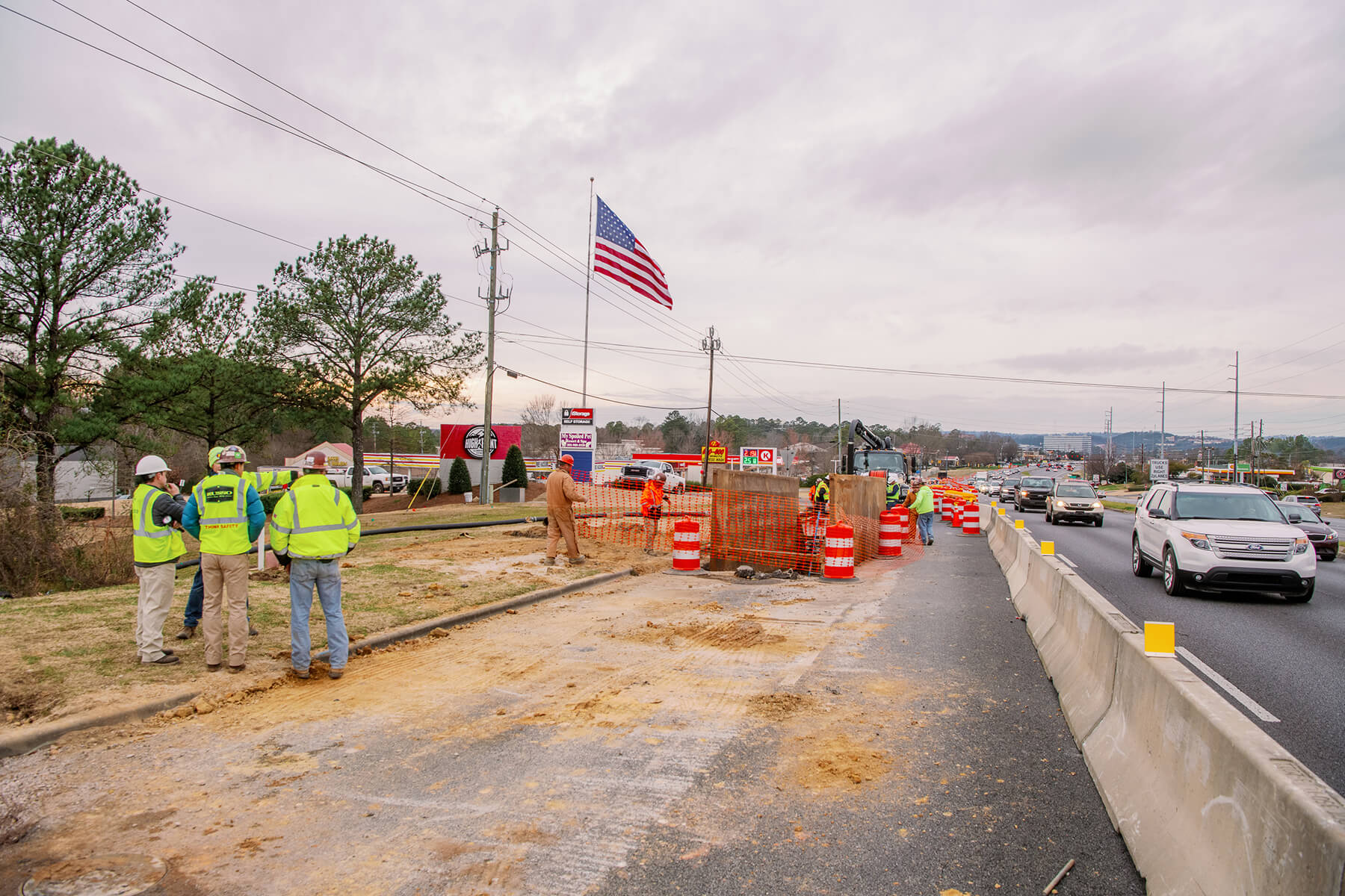 Section of U.S. Highway 280 under repair with U.S. flag in background.