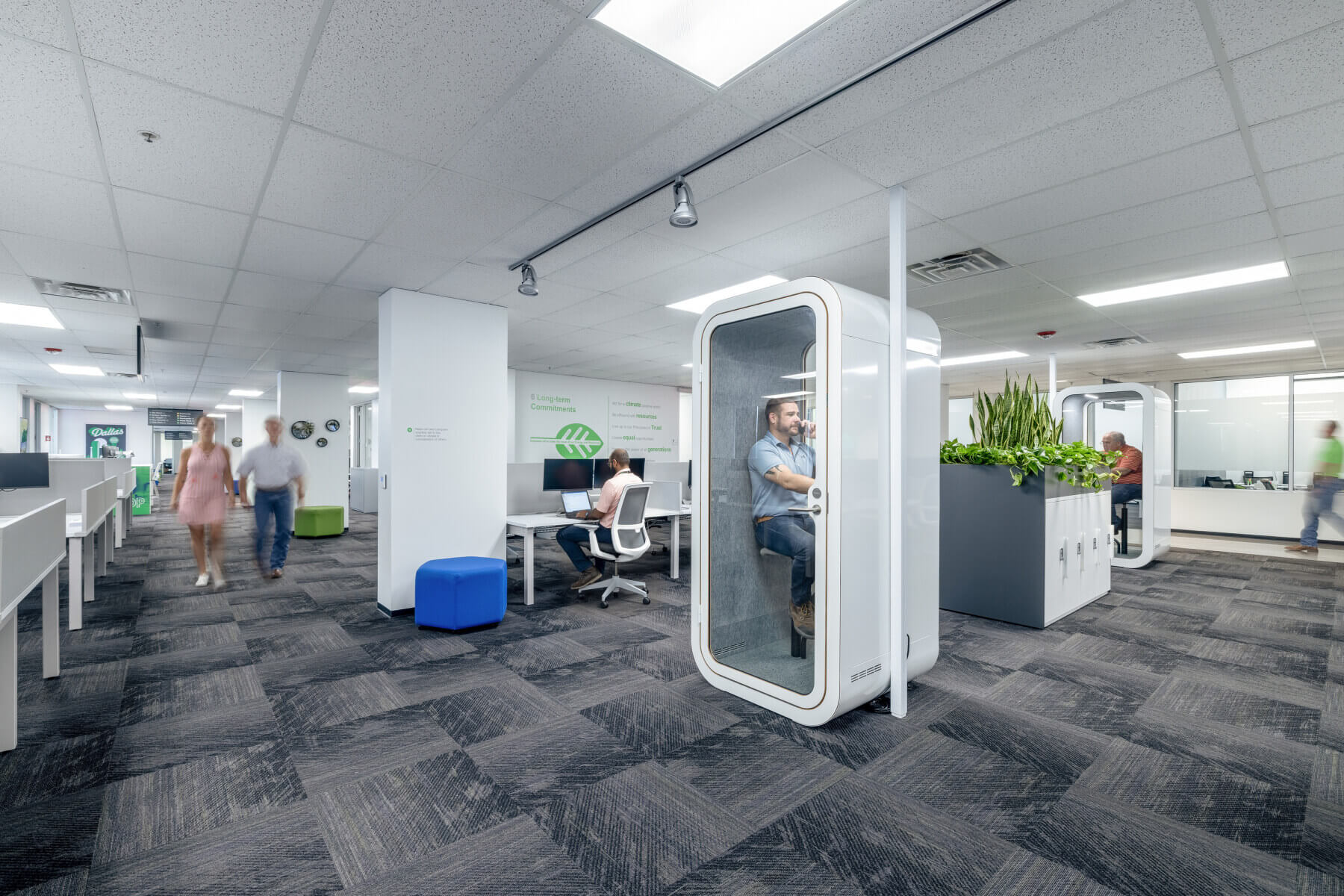 An active work area with a phone booth in the Schneider Electric Offices