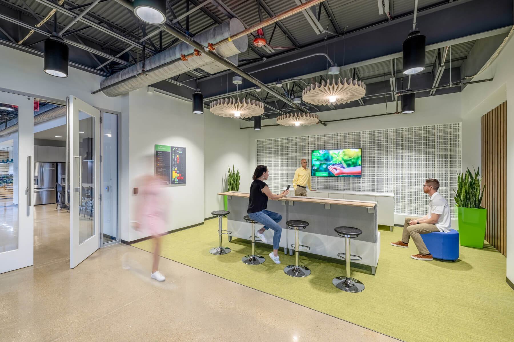 An active work area with a tv and seating in the Schneider Electric Offices