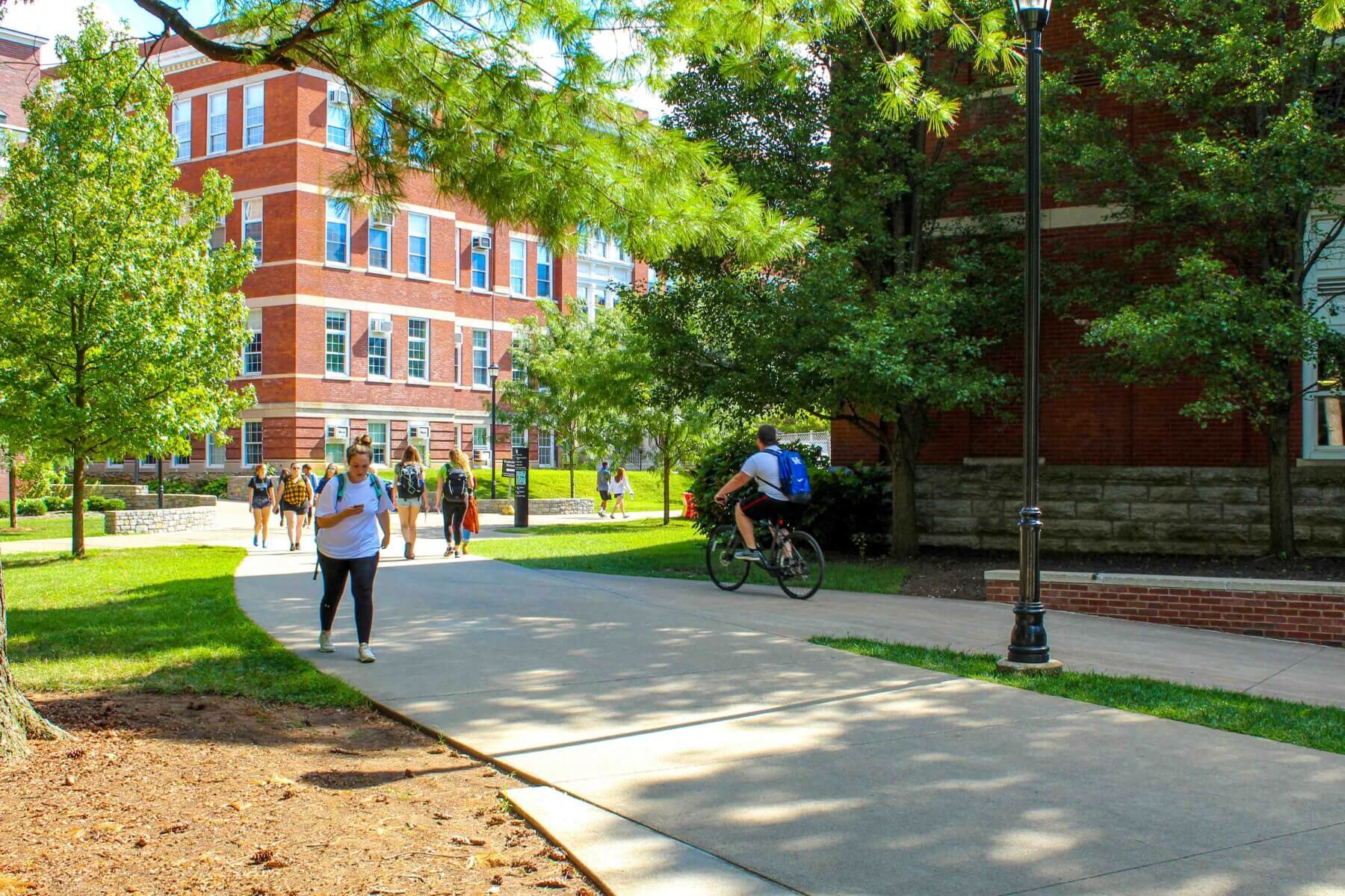 students walking and biking on UK campus