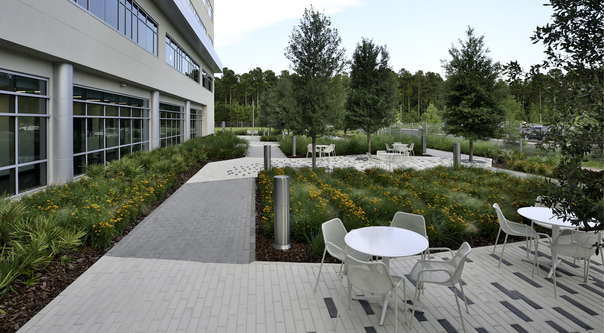 Patio with tables and chairs and plants outside a hospital