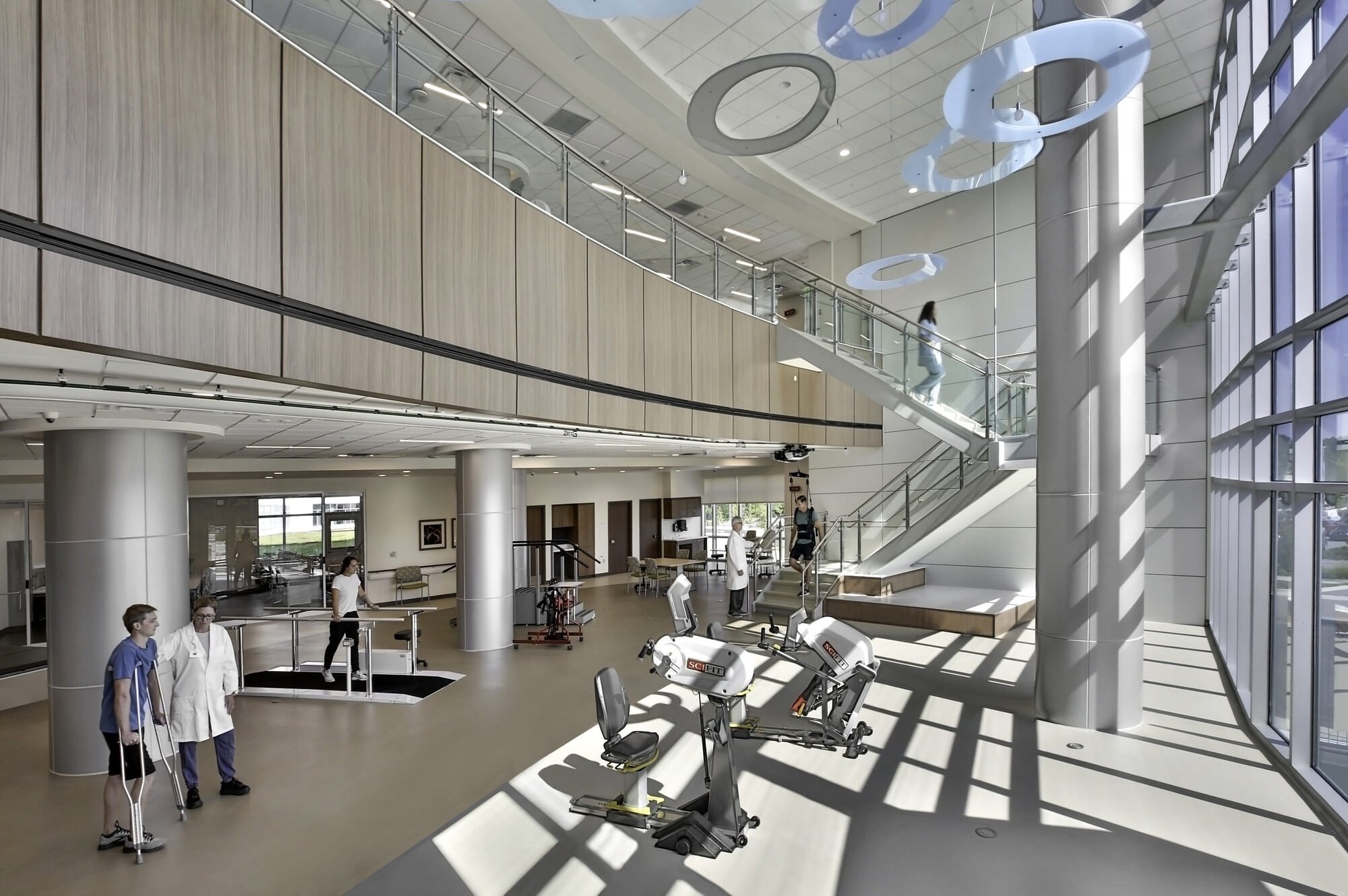 Patients and doctors in a two story rehabilitation gym