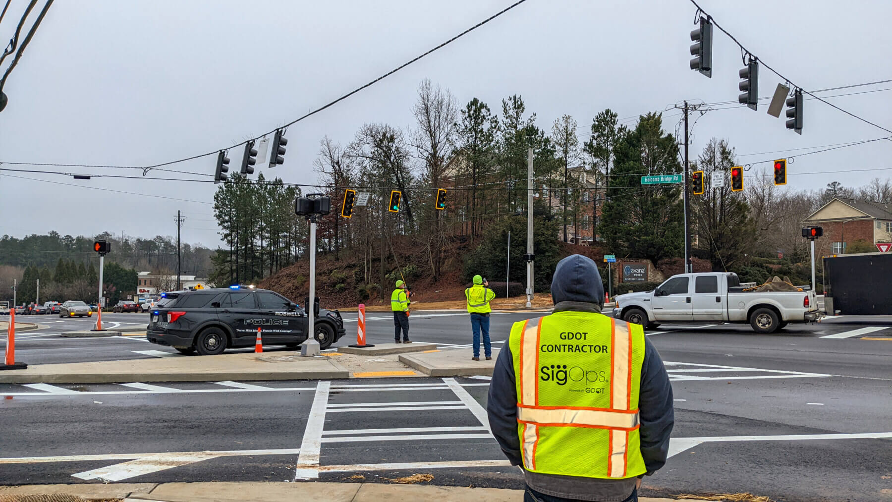 An intersection with a person walking in a GDOT vest