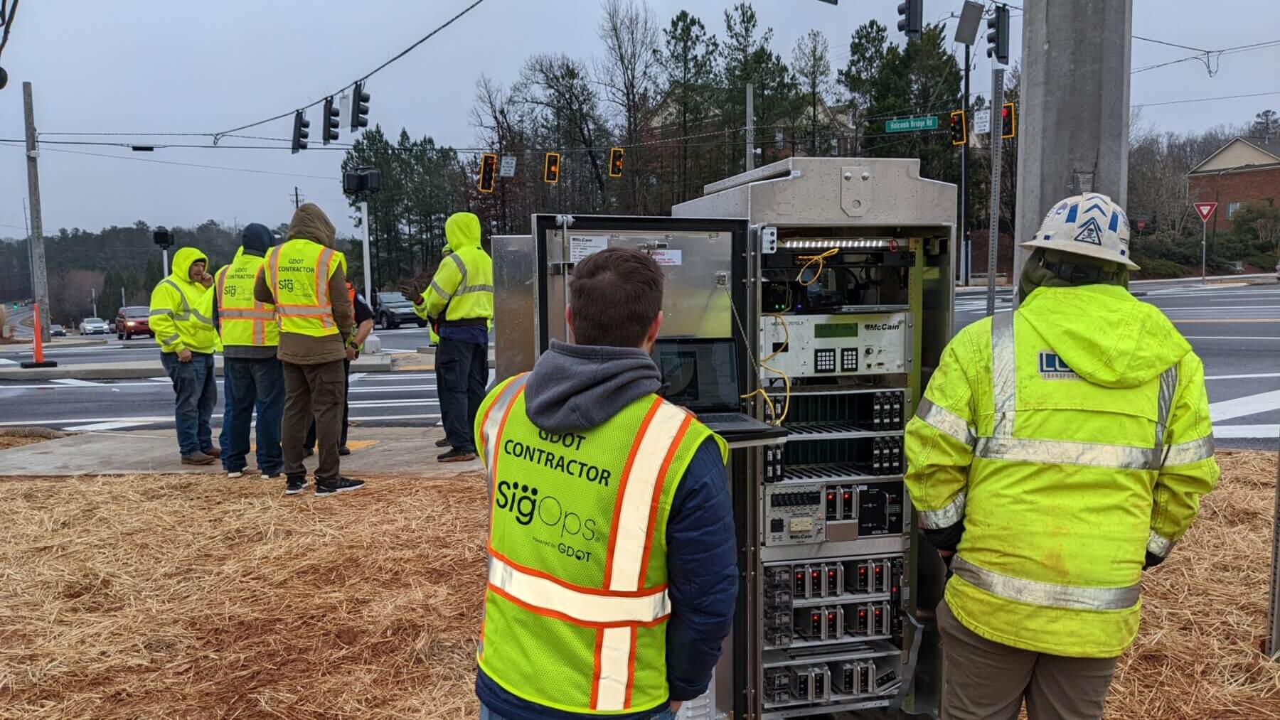 A group of people in yellow vests at a crosswalk for GDOT SigOps