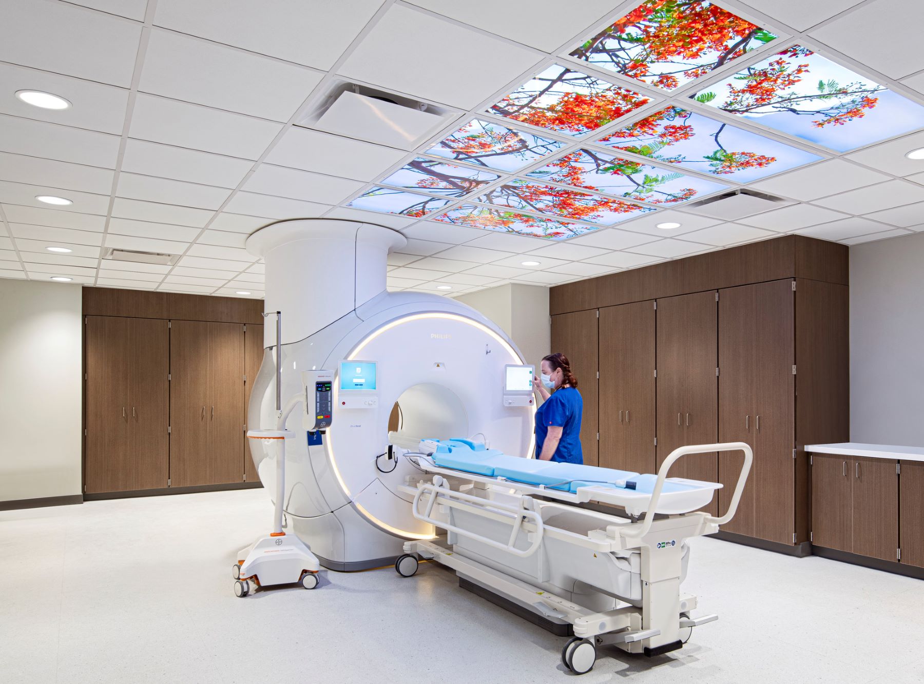 A nurse standing next to an MRI machine