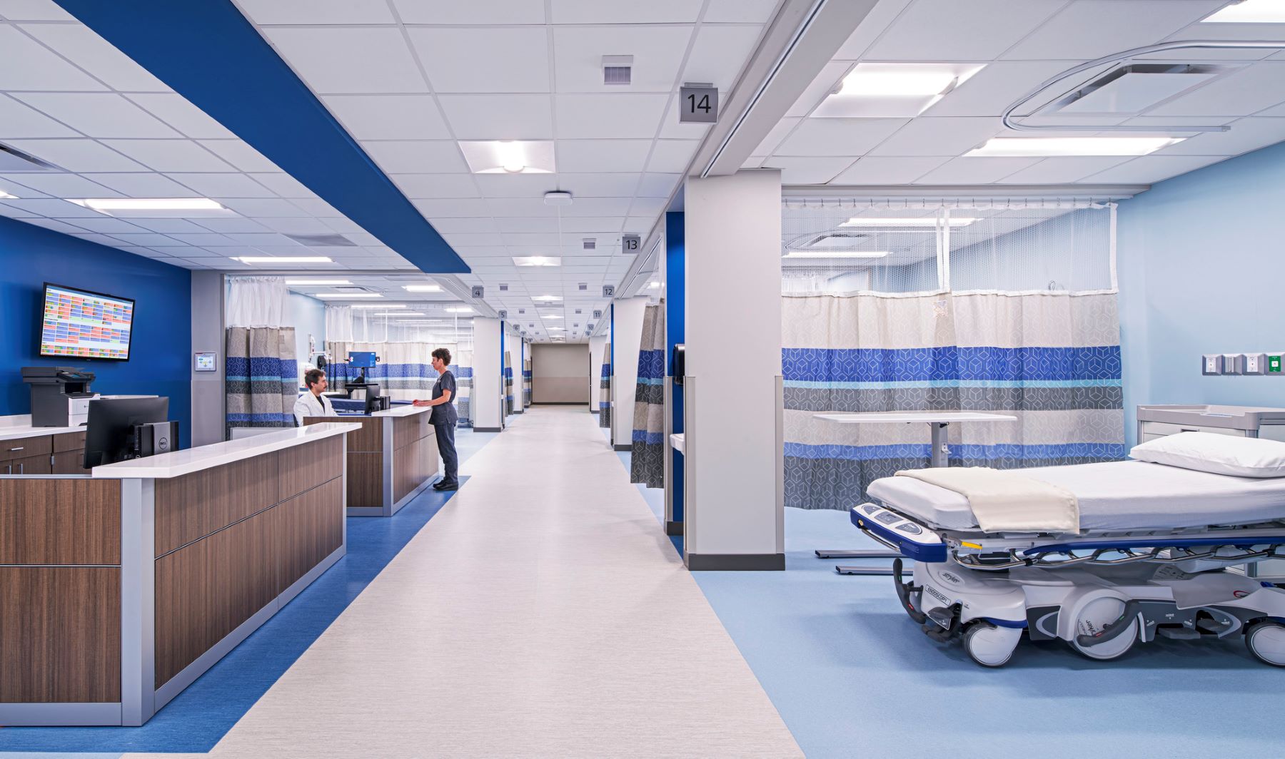 A nurse speaking to a doctor in a prep or post-operative care unit