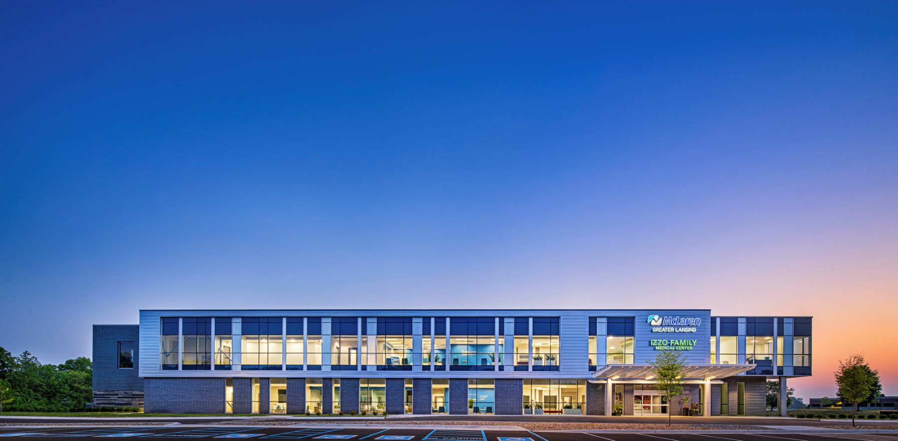 straight on view of the exterior of a two-story medical office building at dusk